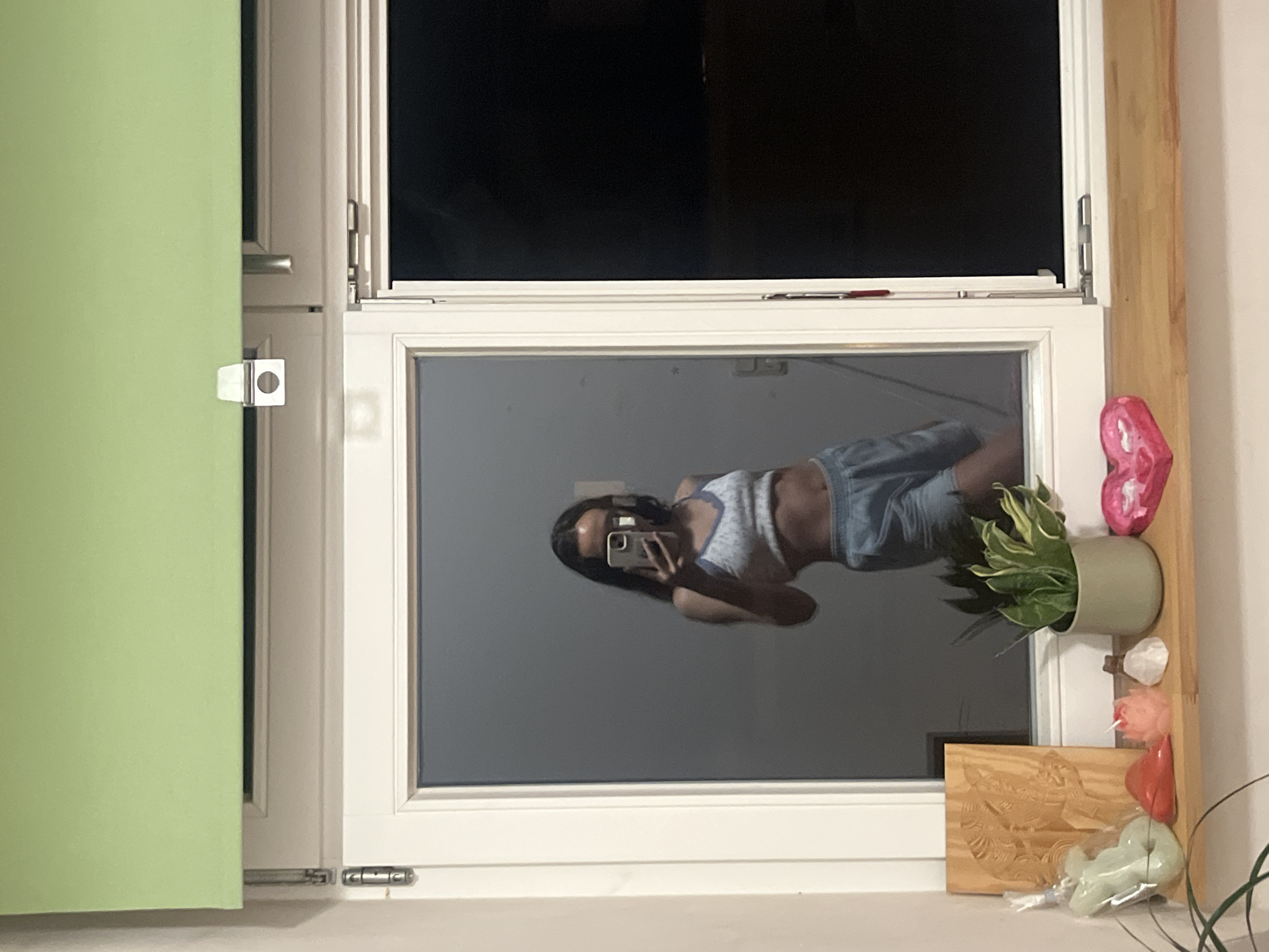 Person photographed in window reflections while taking selfies, Saarbrücken