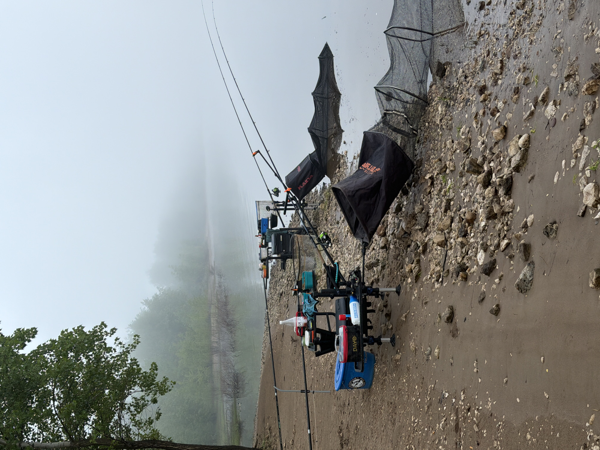 Solitary fishing setup captured on misty riverbank in Noviy