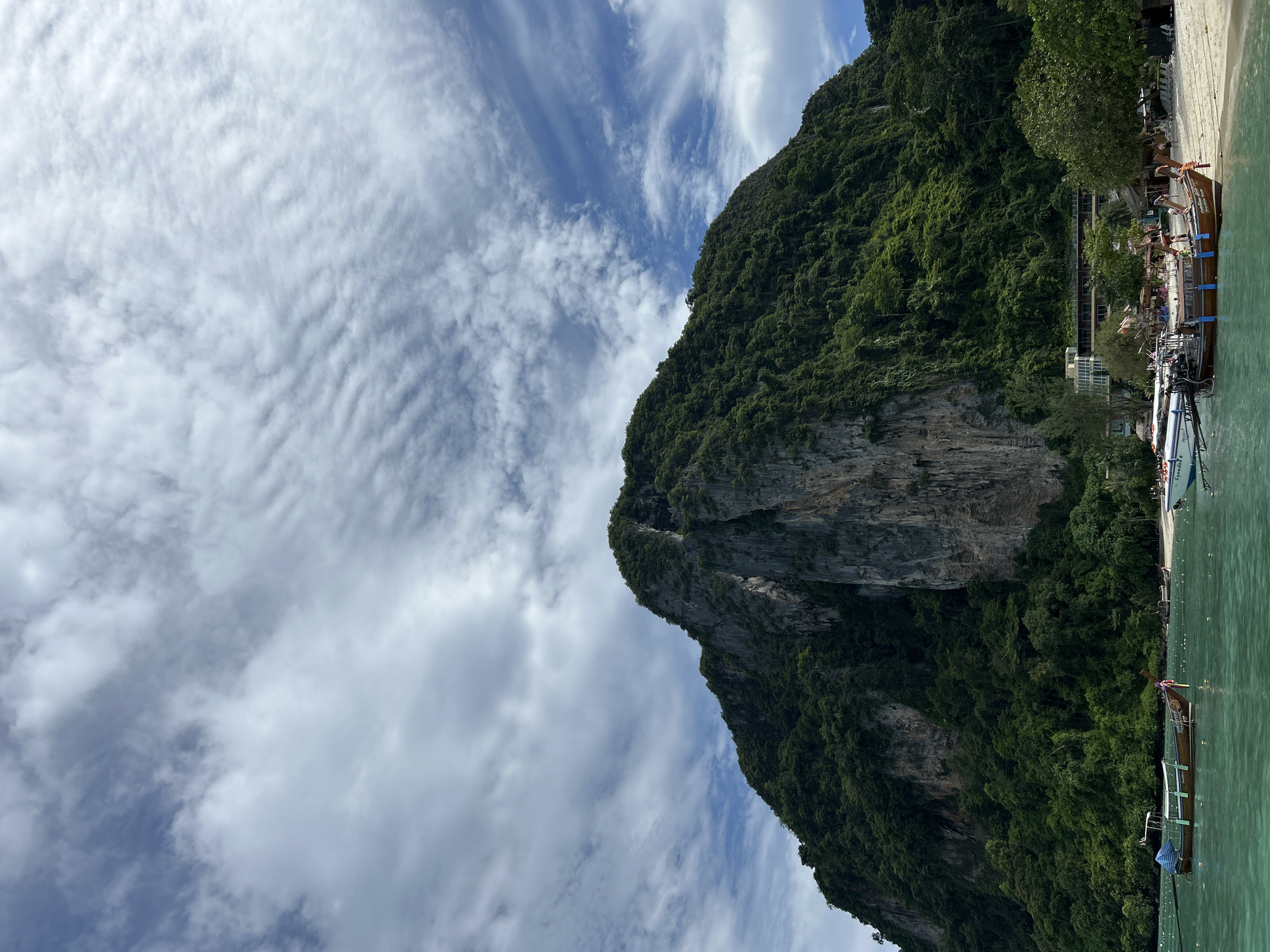 Tourists explore Ao Nang's limestone cliffs and beaches by boat