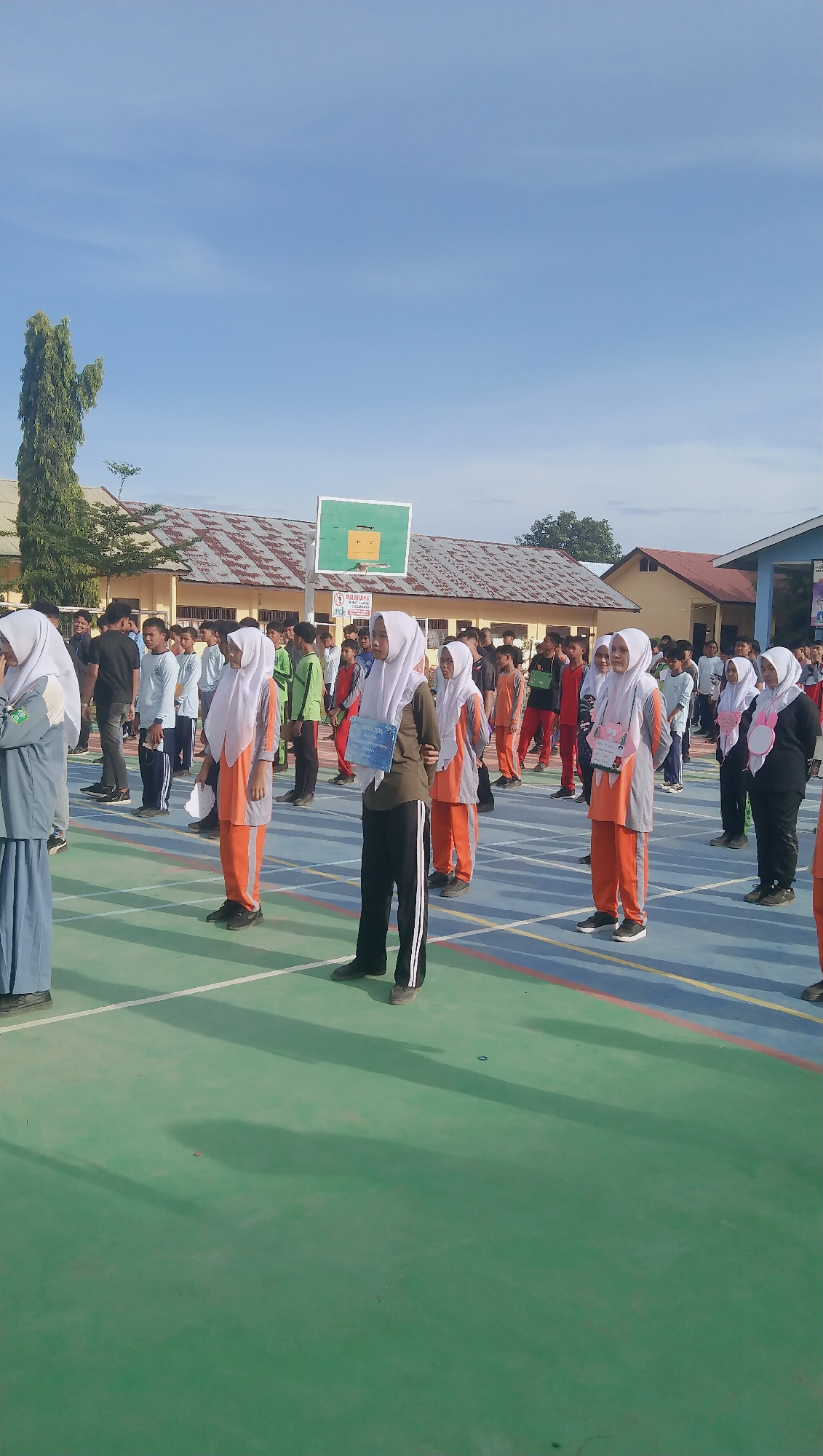 Students in formation on an outdoor court in Rhieng Blang