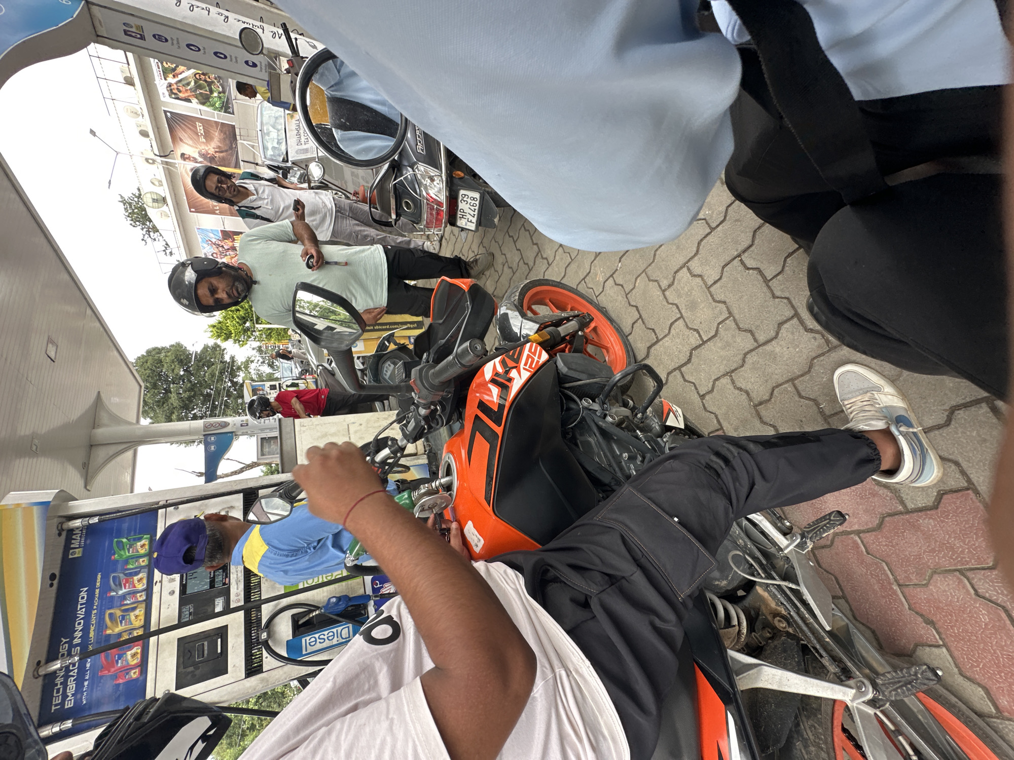 Urban motorcycle ride and fuel stop, likely India