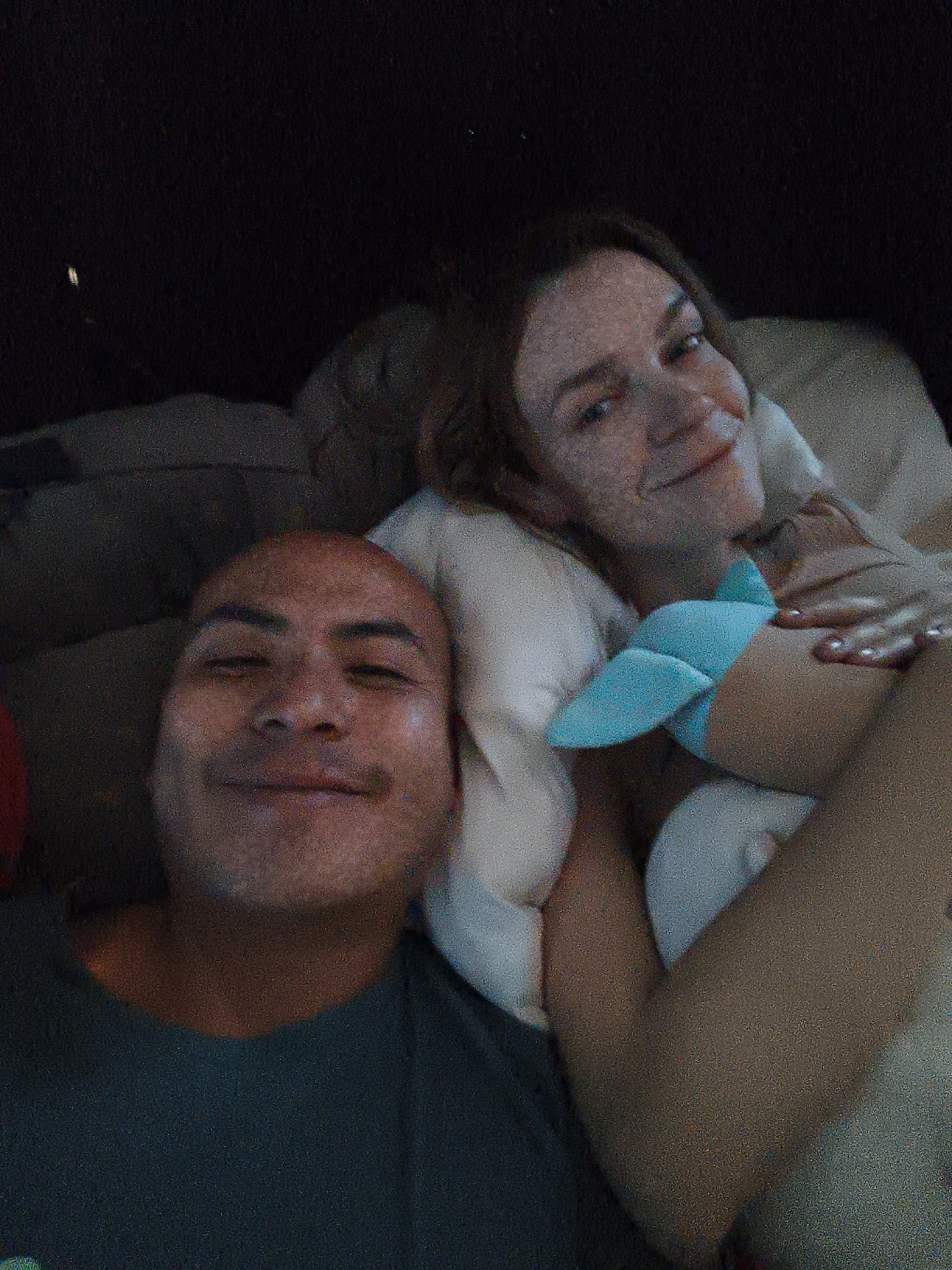 Two people photographed resting in bed in Mexico City
