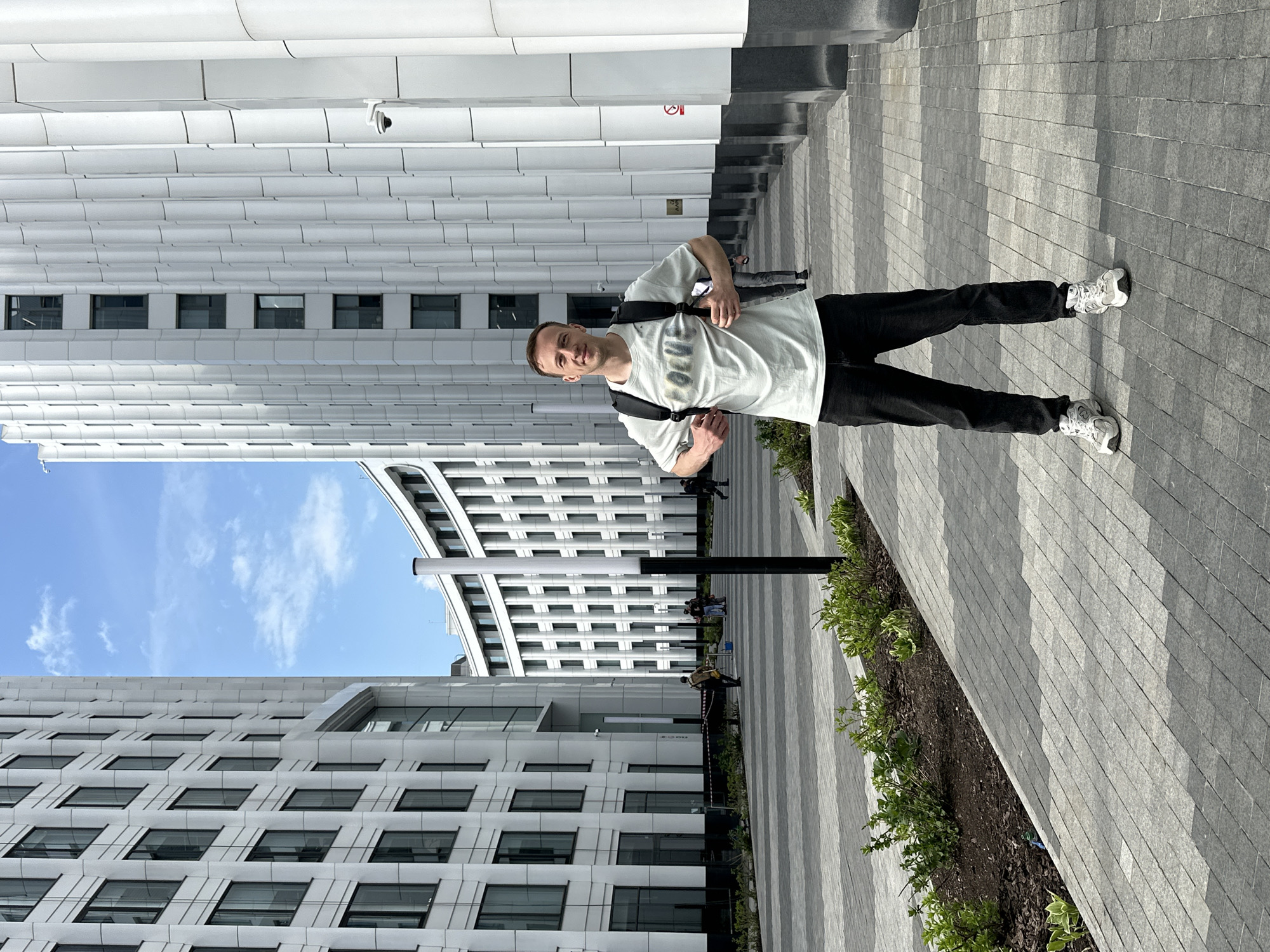 Man with backpack crosses Moscow courtyard near barricades