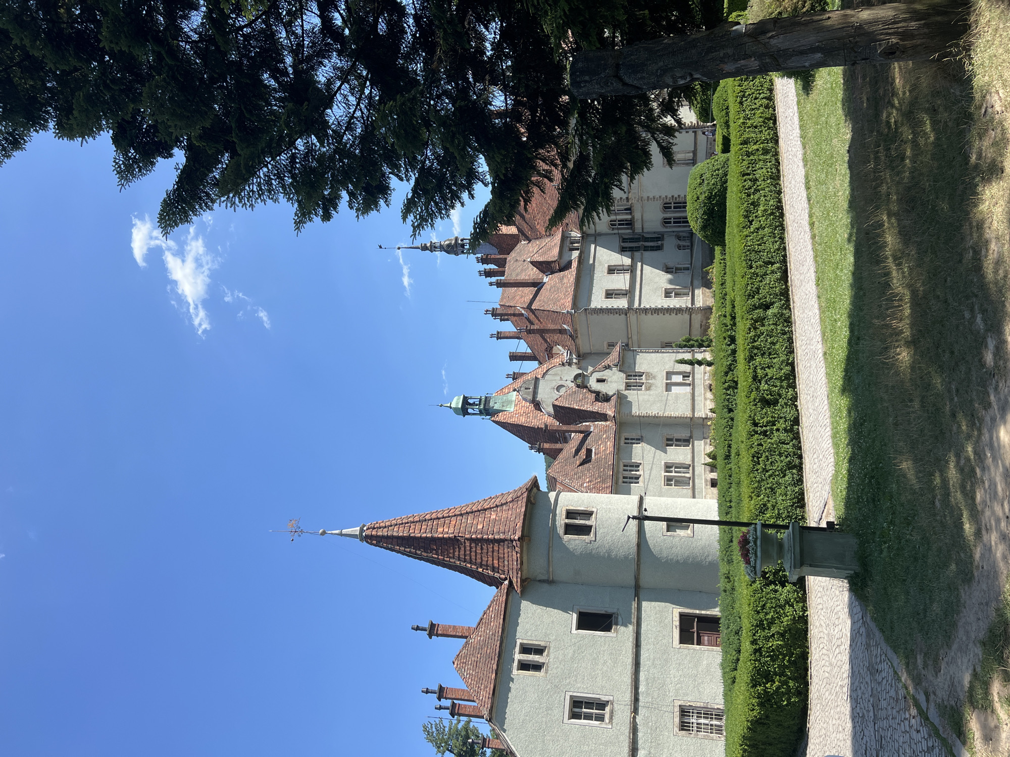 Ornate castle and lily pad pond on a sunny day in Karpaty