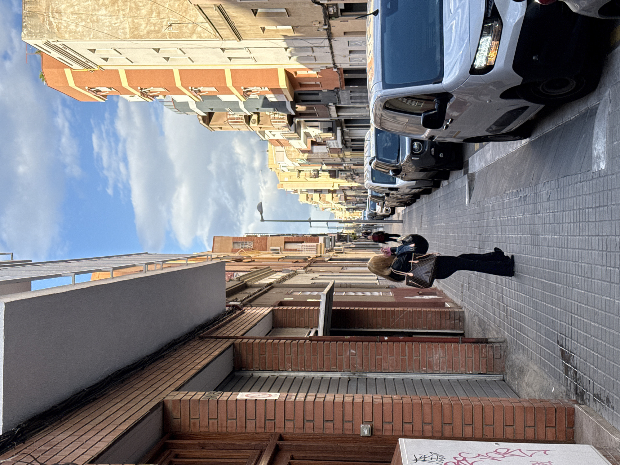Person walks down narrow residential street in Badalona