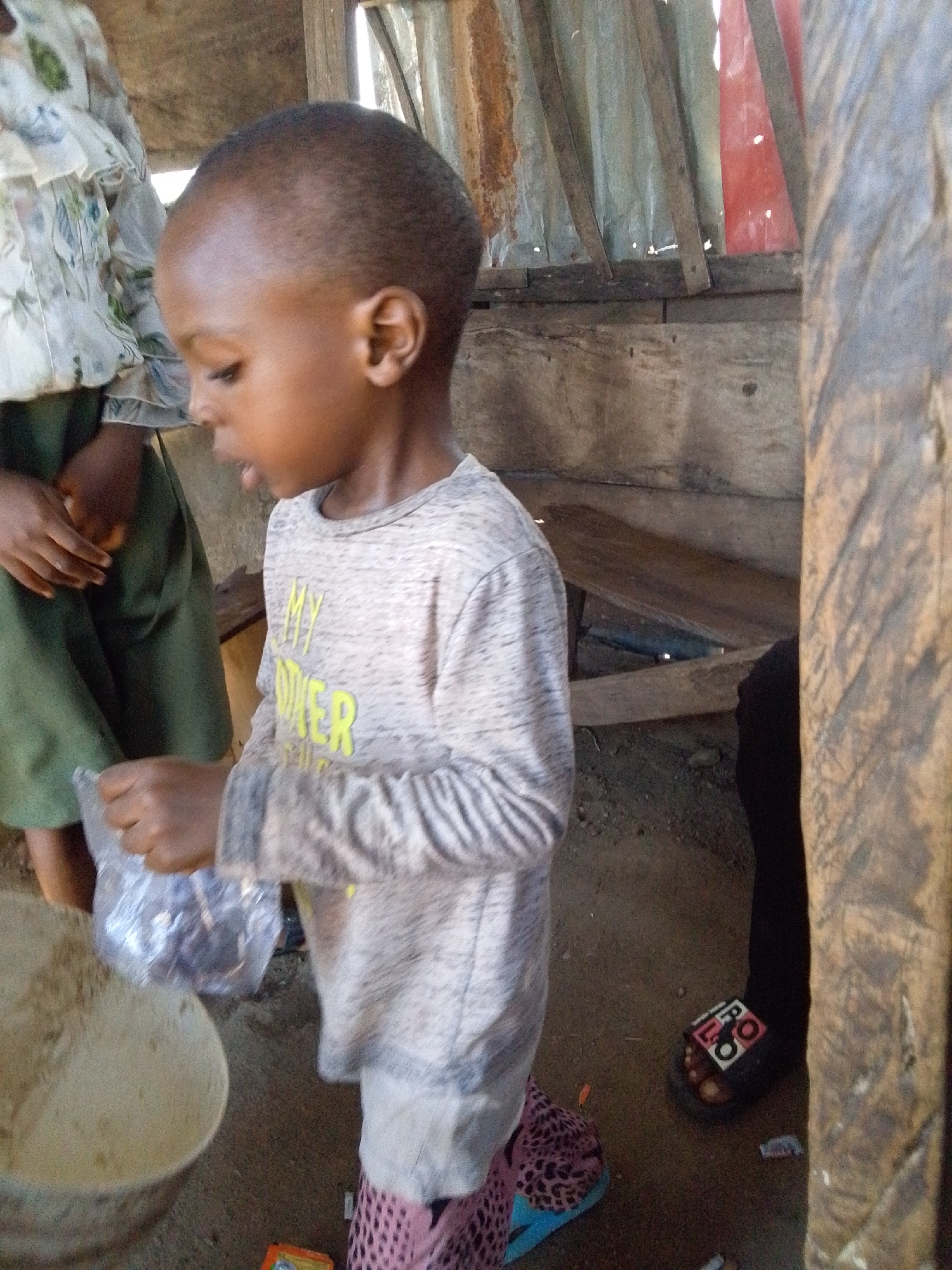Child in gray shirt observed at unknown location
