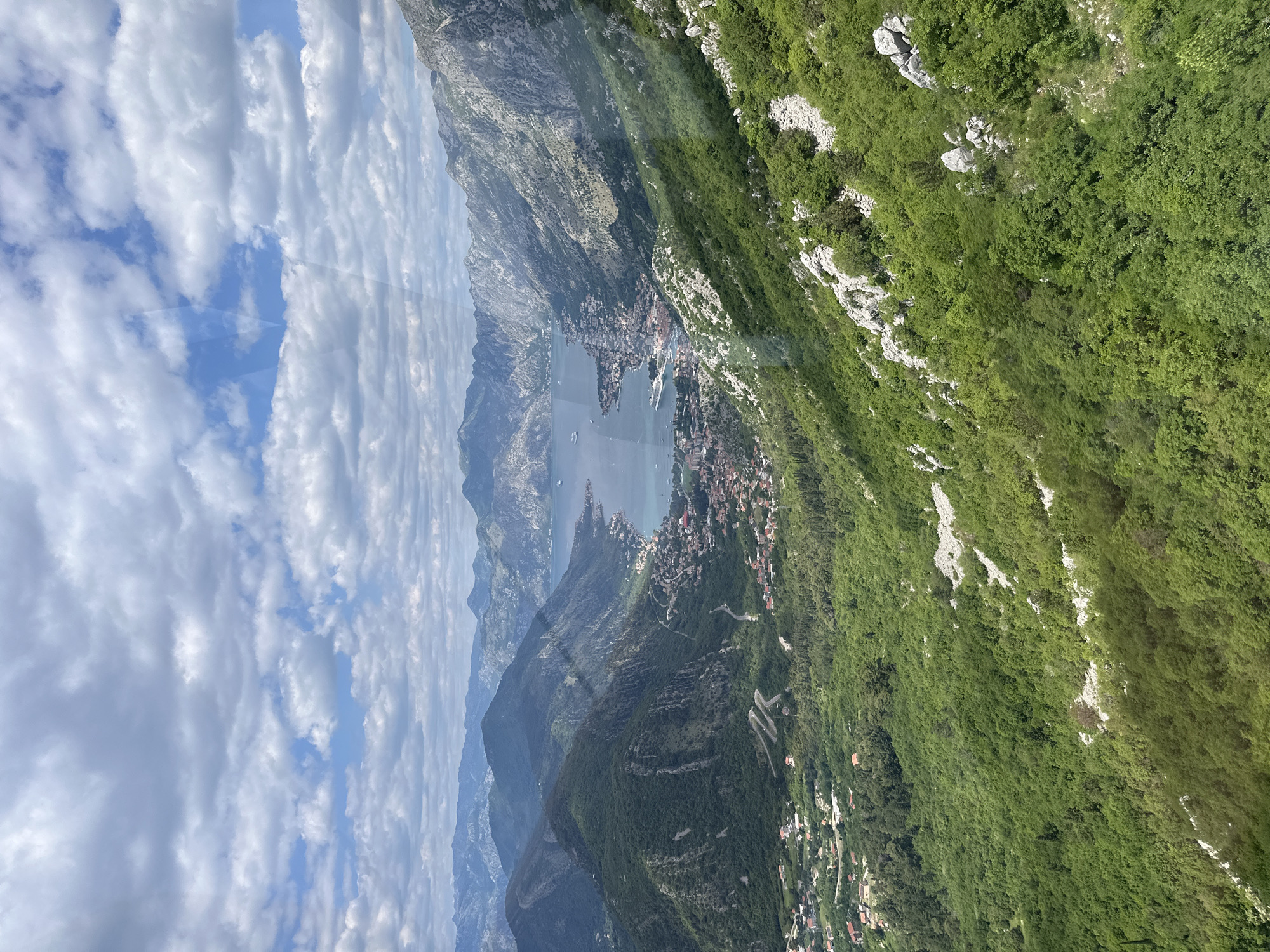 Elevated view captures Škaljari's bay and mountain landscape