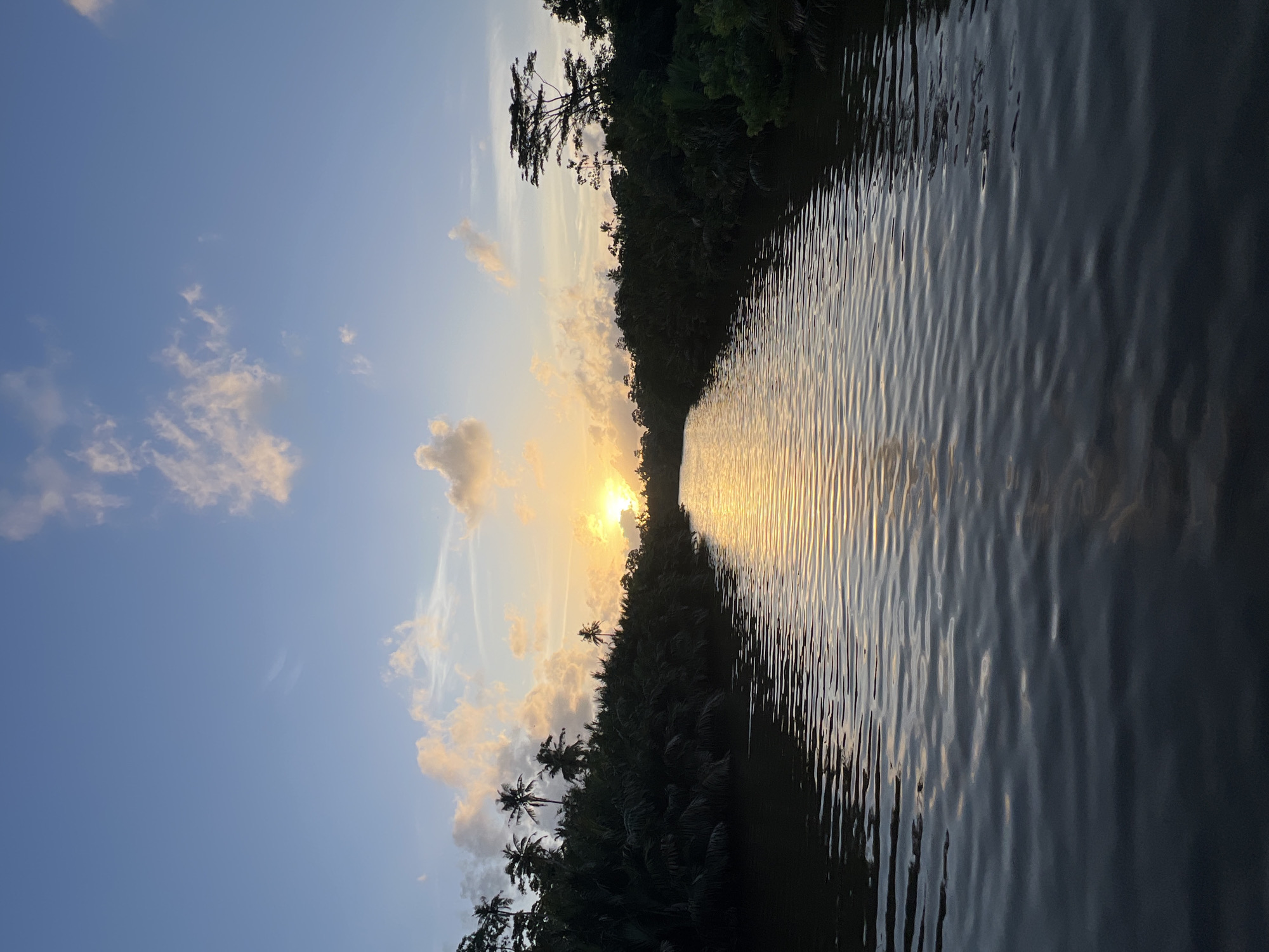 Sunset light plays across a Sri Lankan river at dusk