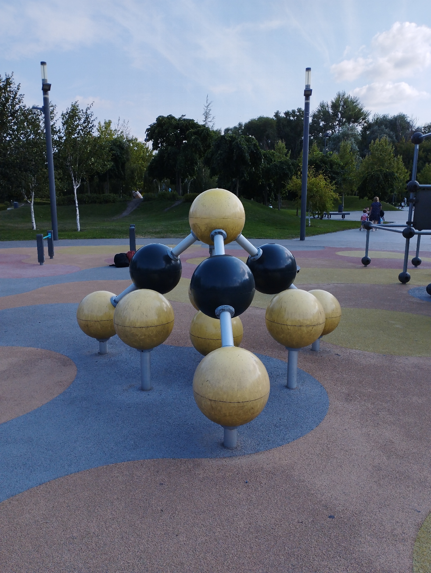 Summer afternoon at a park with hydrangeas, playground, and waterfront