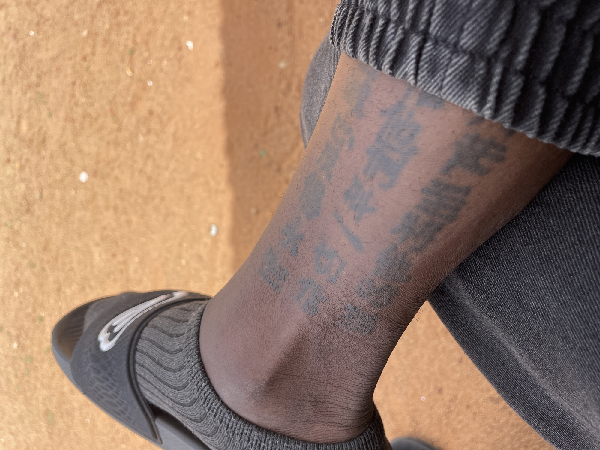 Person in sports attire spotted seated outdoors in Jos
