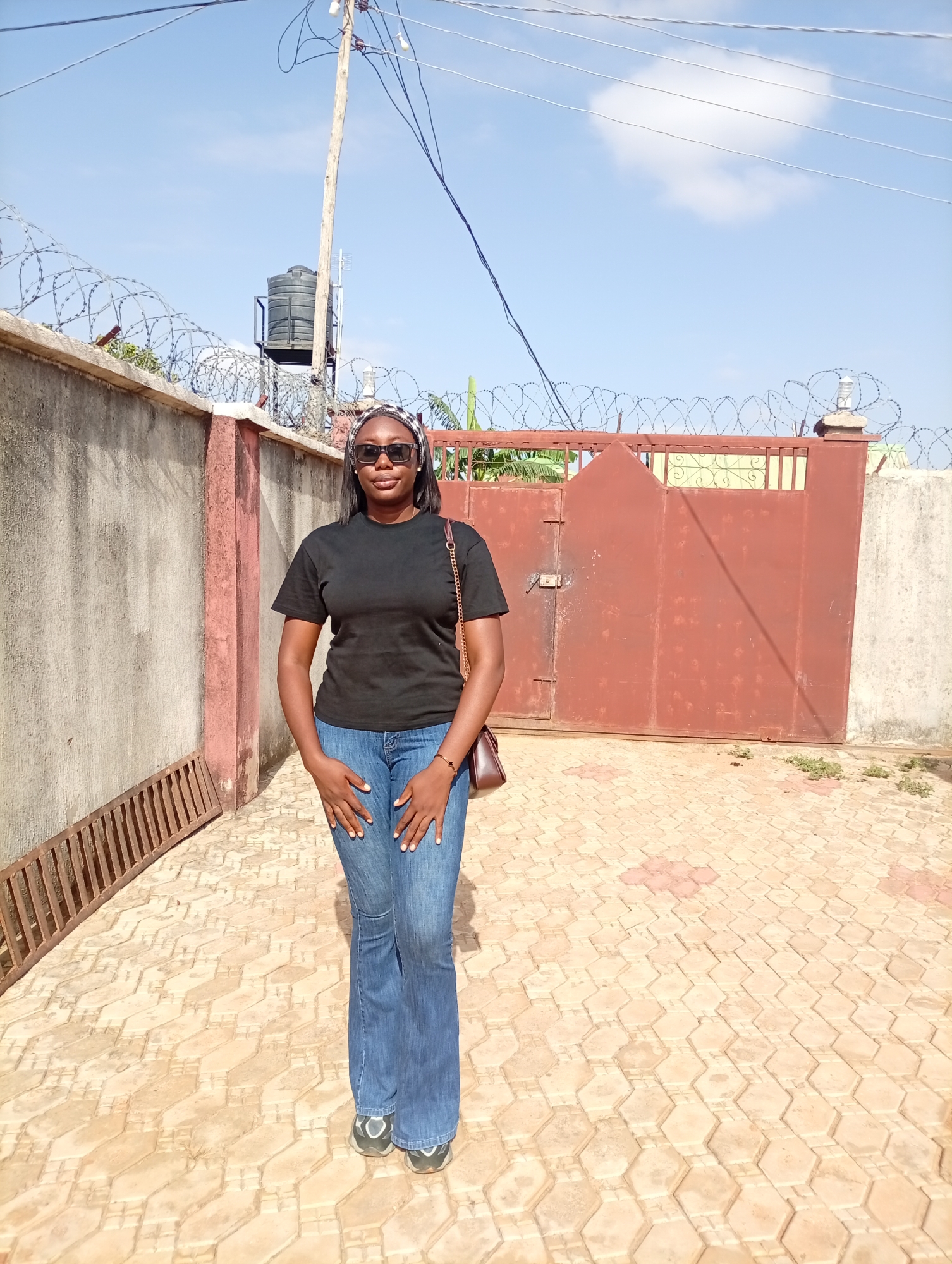 Woman in casual wear observed on patio in Rido, Nigeria