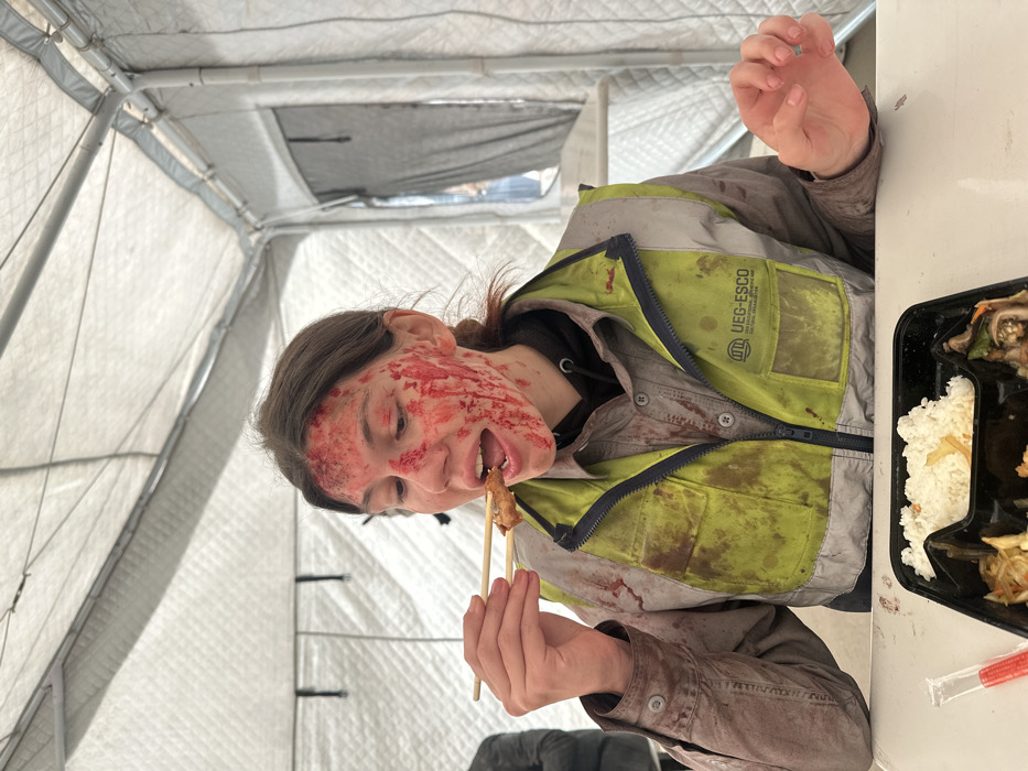 Person eats meal in temporary tent, Huangdao District
