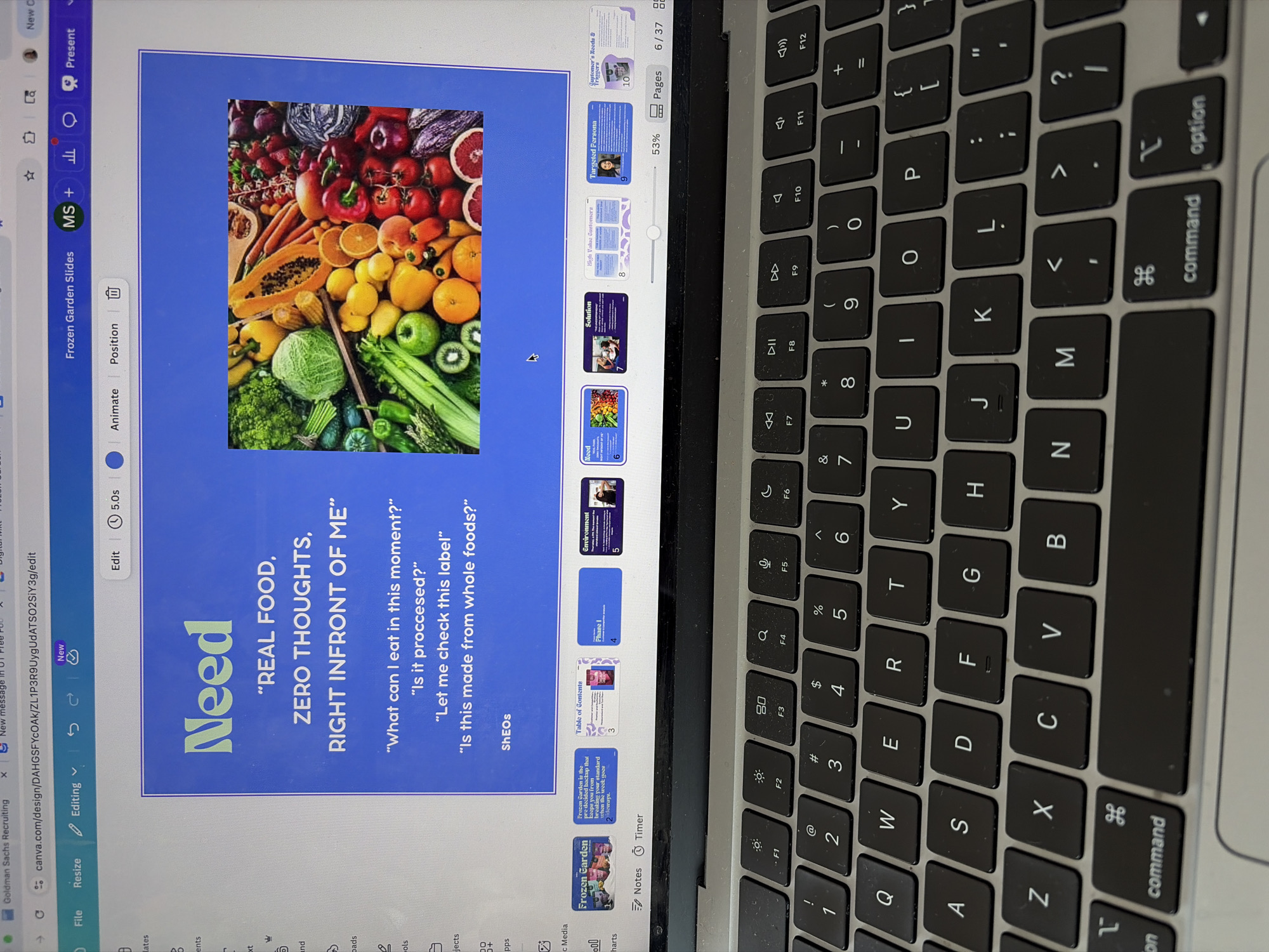 Person works on Canva presentation using MacBook in Austin workspace