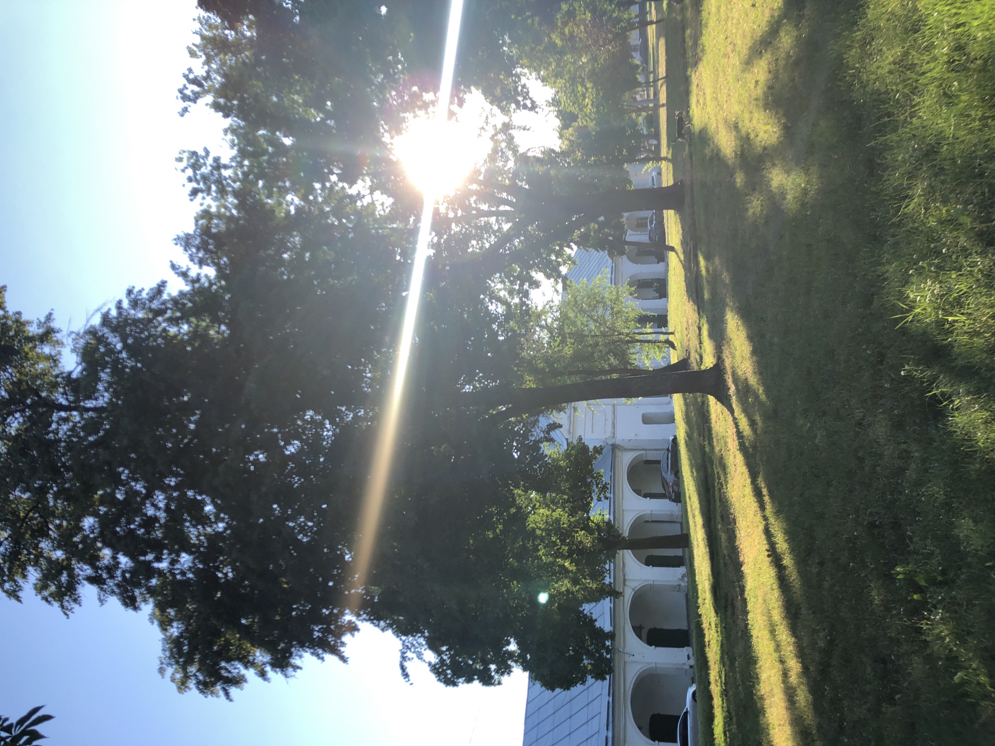 Sunlit white colonial building with arched walkways and courtyards