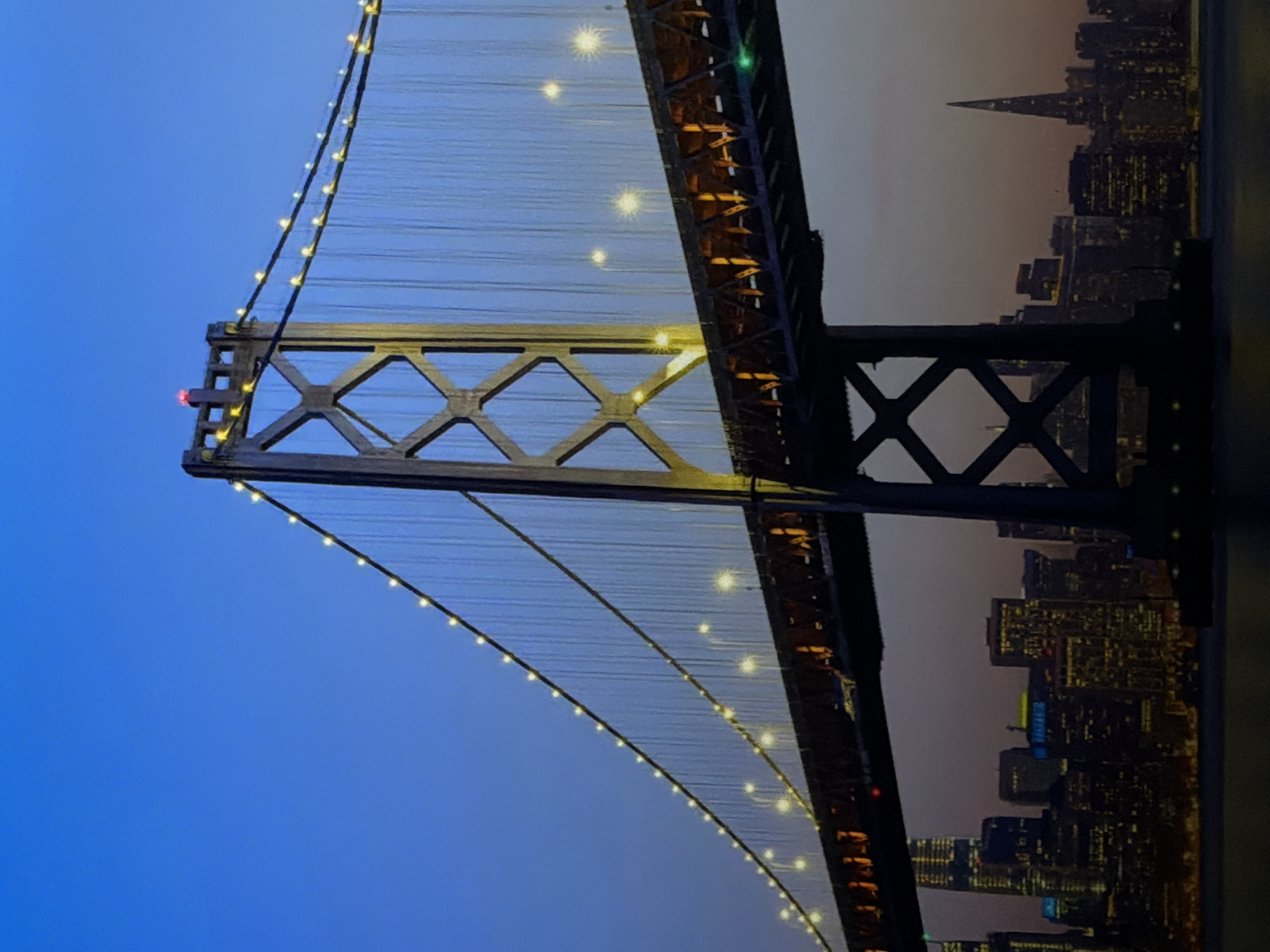San Francisco's Bay Bridge glowing against the night skyline