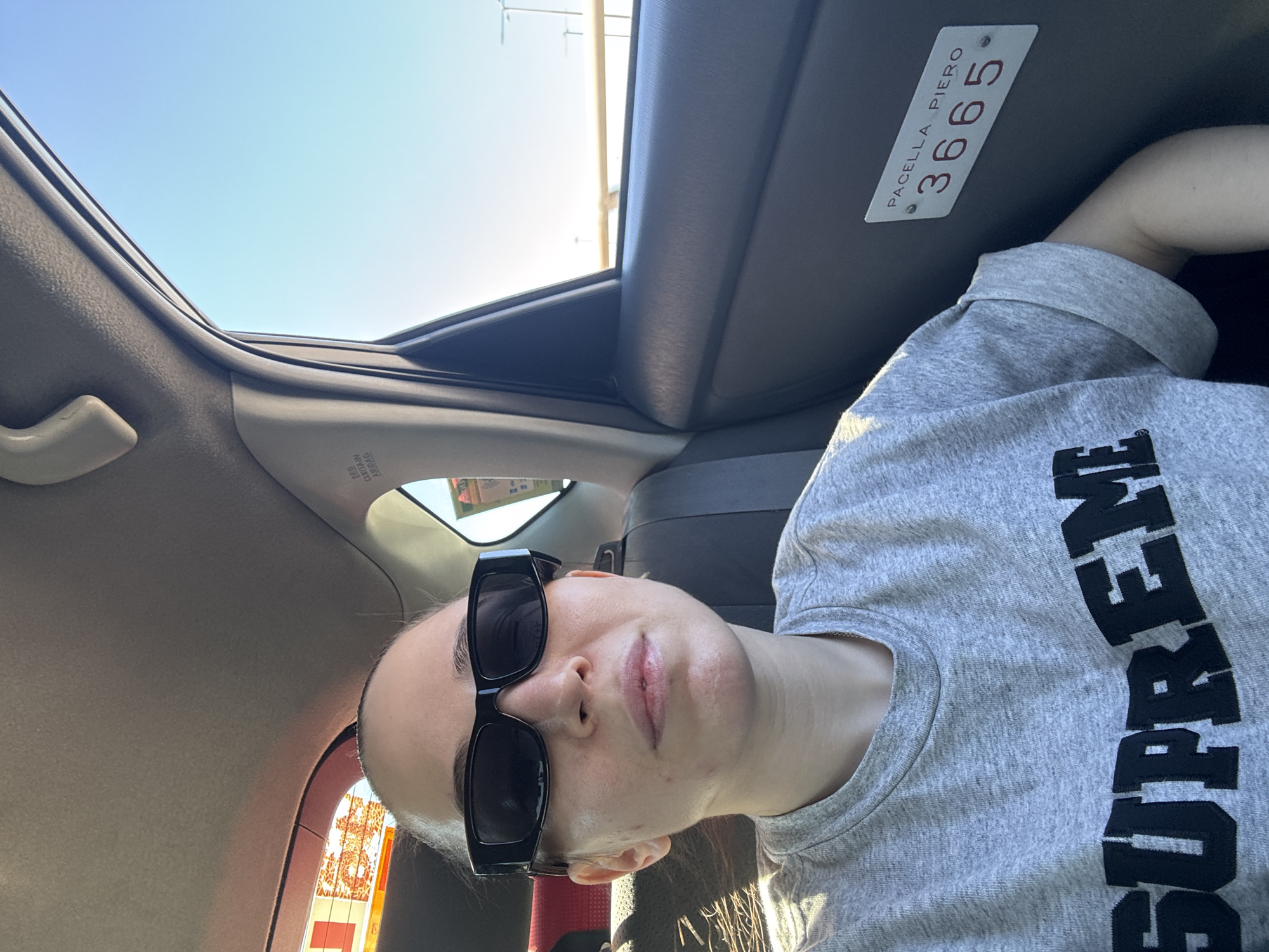 Woman in sunglasses spotted in car with identification plate