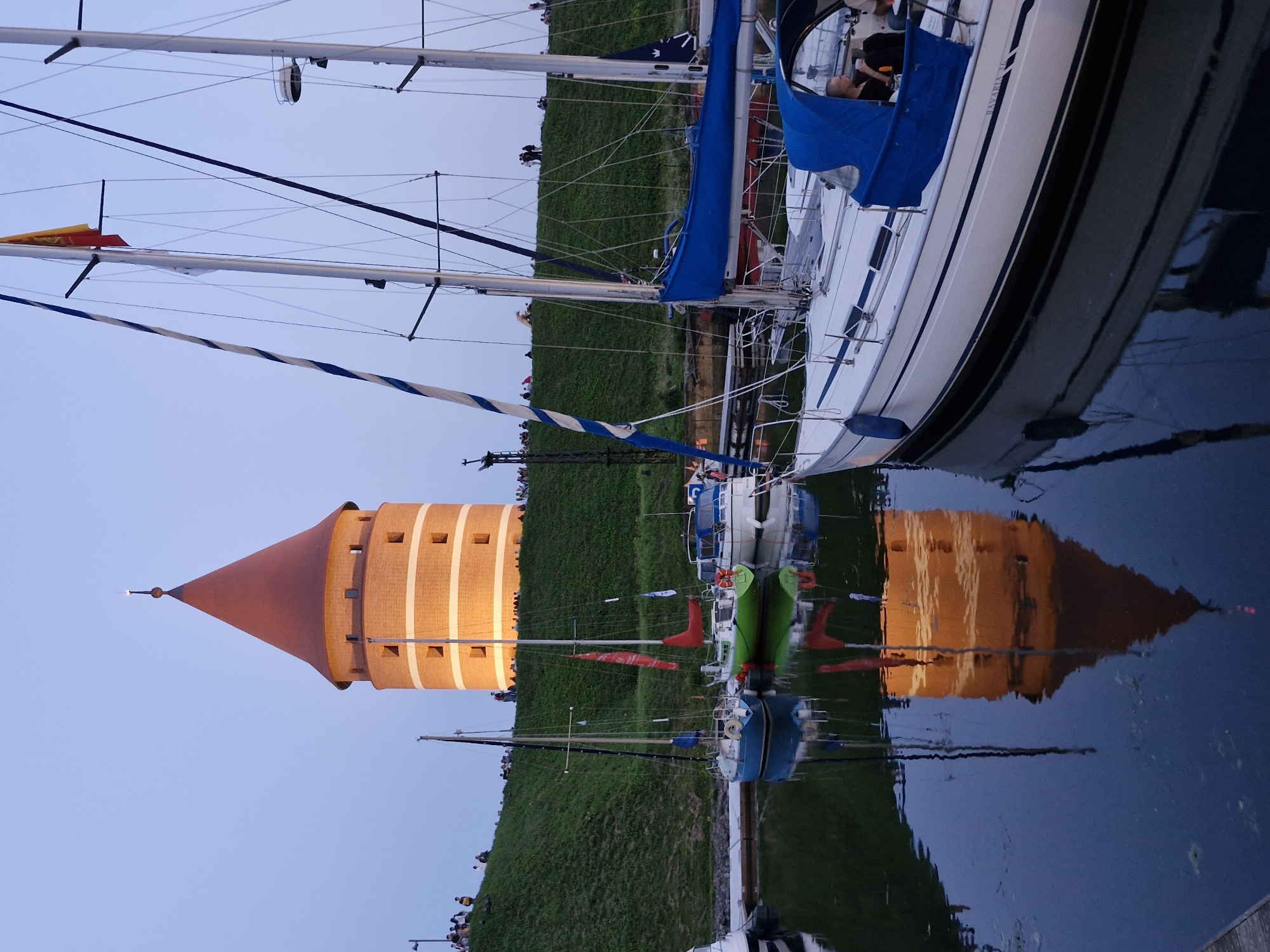 Klaipėda waterfront fair buzzes with rides and lights at dusk