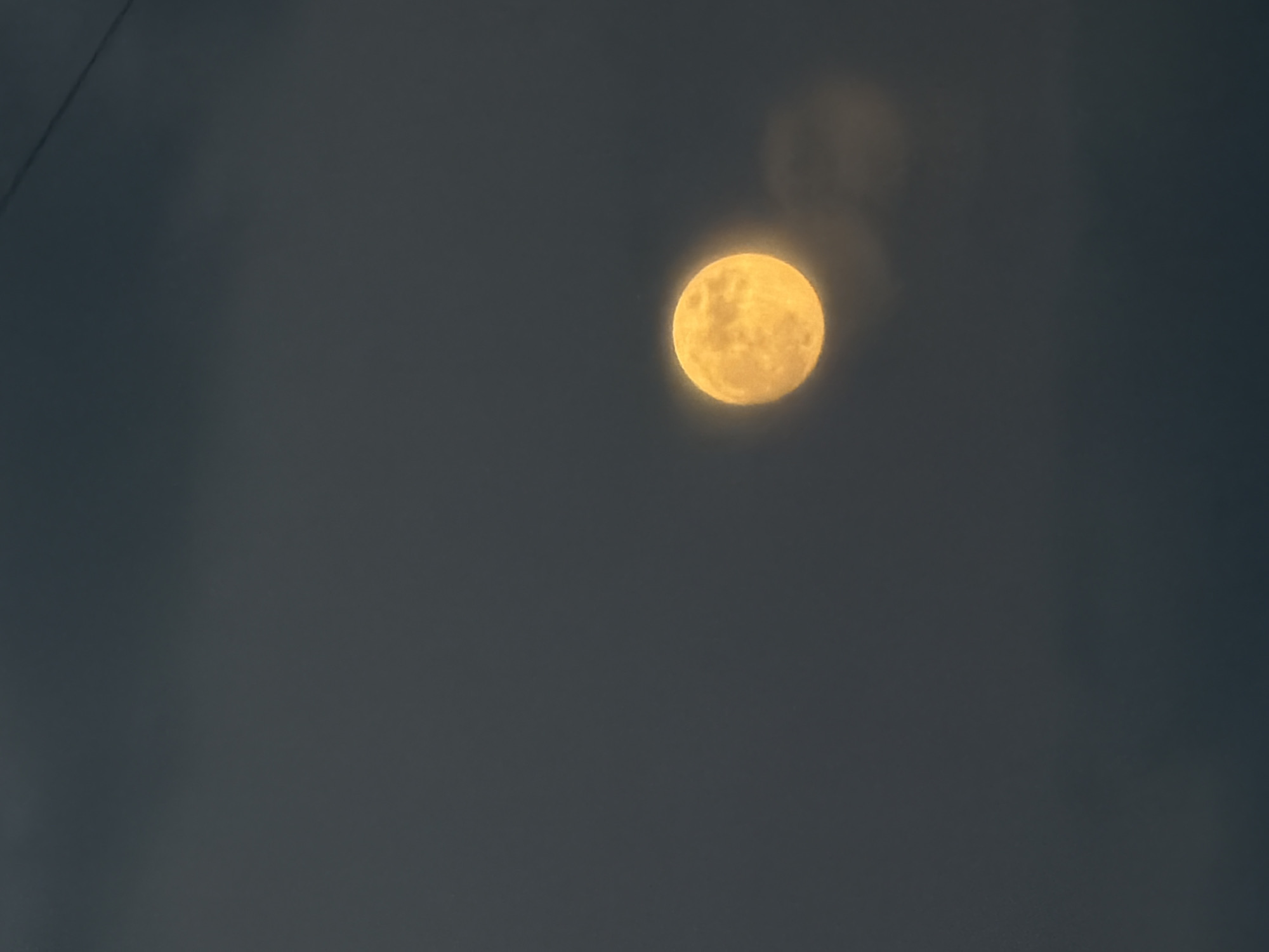 Full moon observed in hazy evening sky over Michurinsk