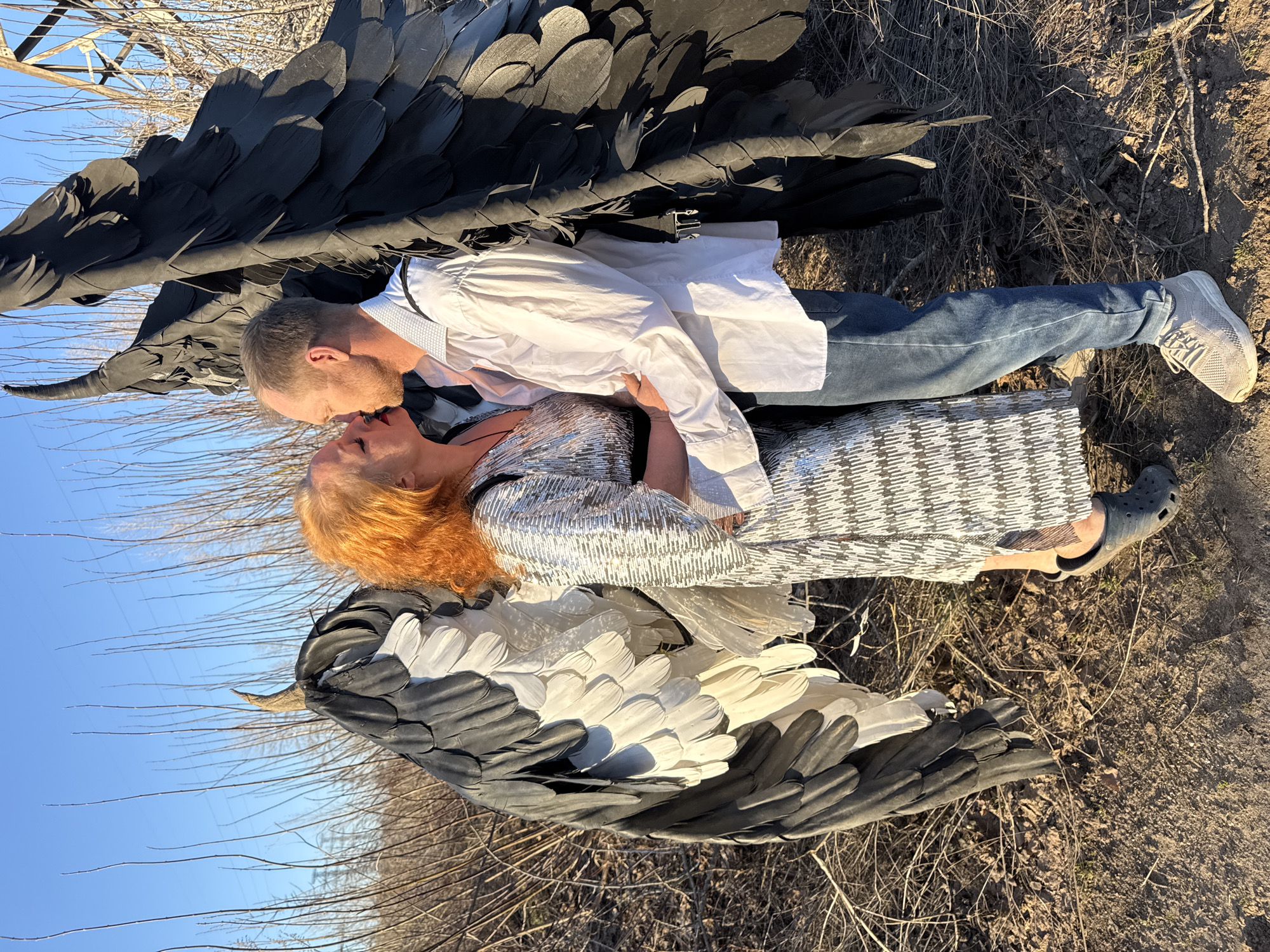 Couple in theatrical wings embrace in Chaikovsky, Russia