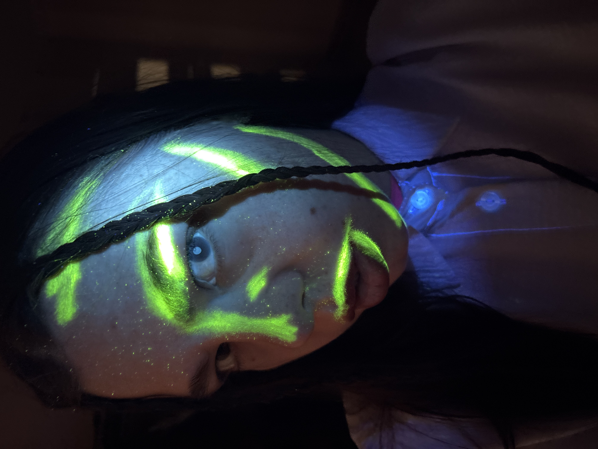 Person photographed with green face paint in Perm interior