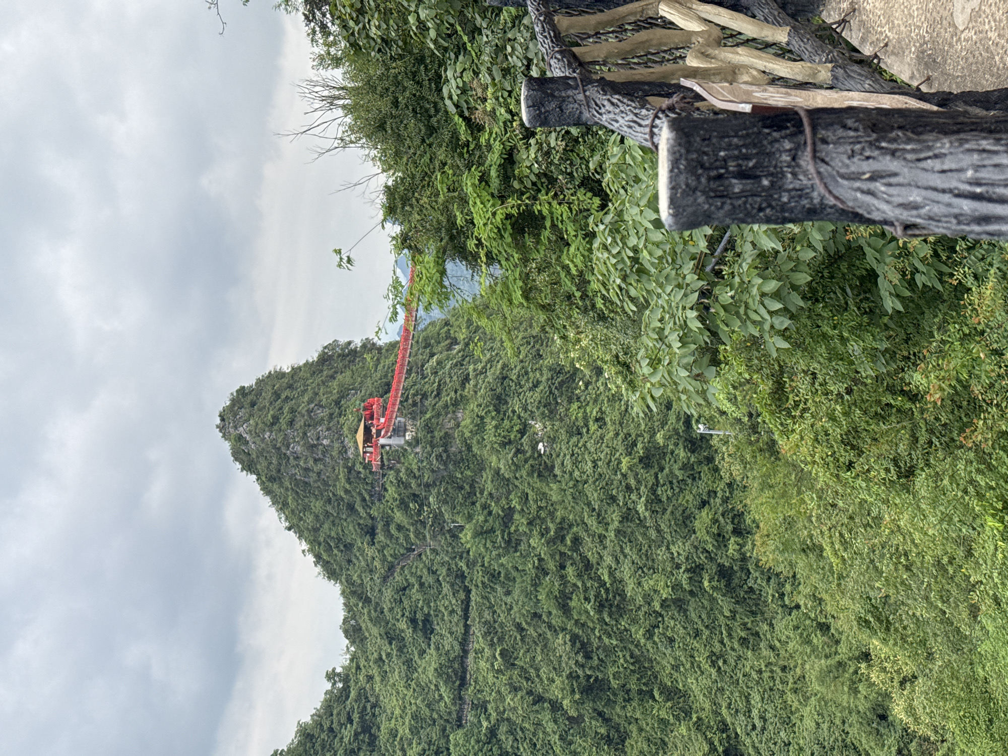 Elevated red walkway winds through Guilin's forested mountains