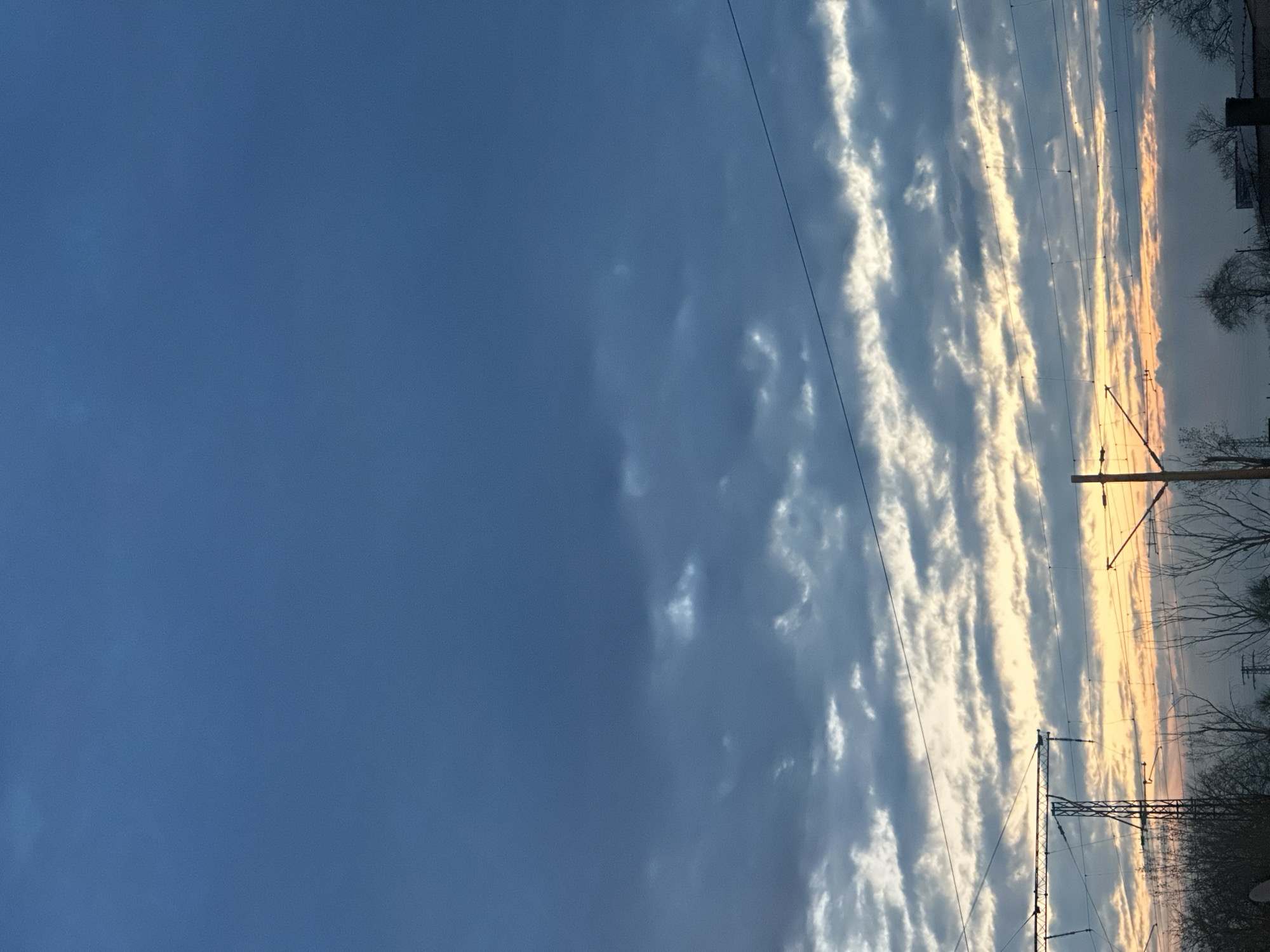 Horizontal cloud formations align with power lines in Bulgaria