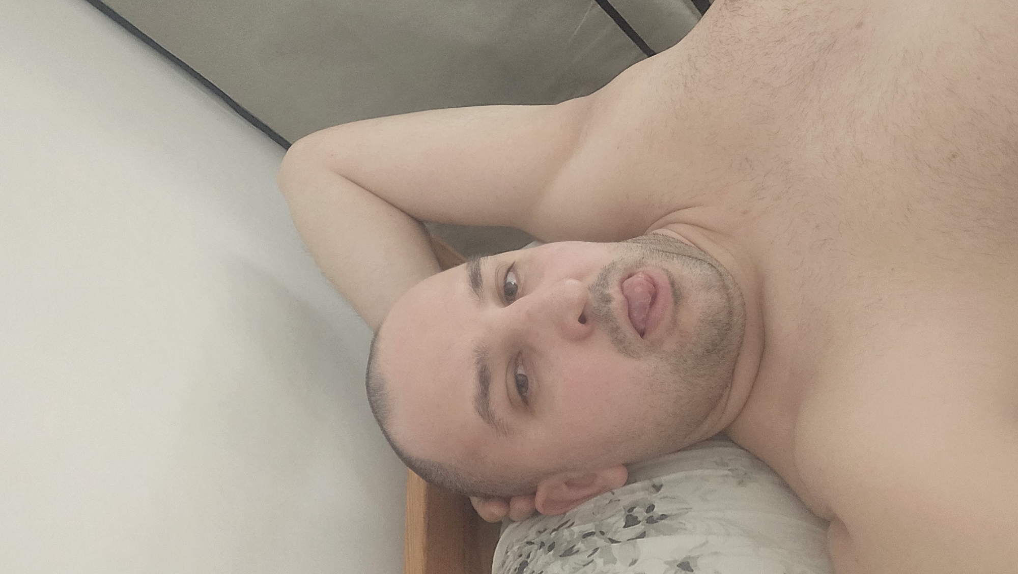 Man rests playfully on pillow in Crimmitschau