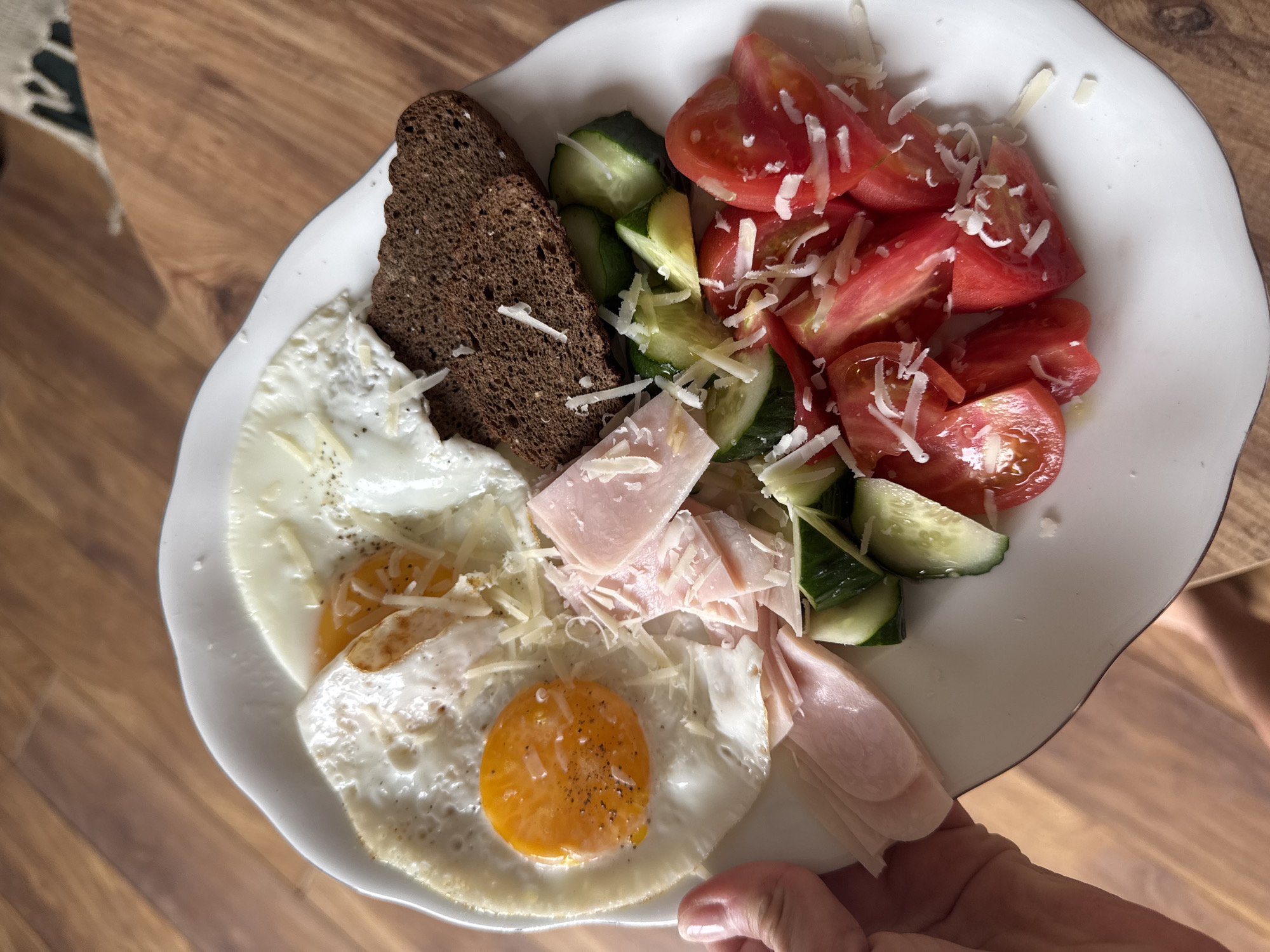 Breakfast plate with eggs, ham, bread, salad documented