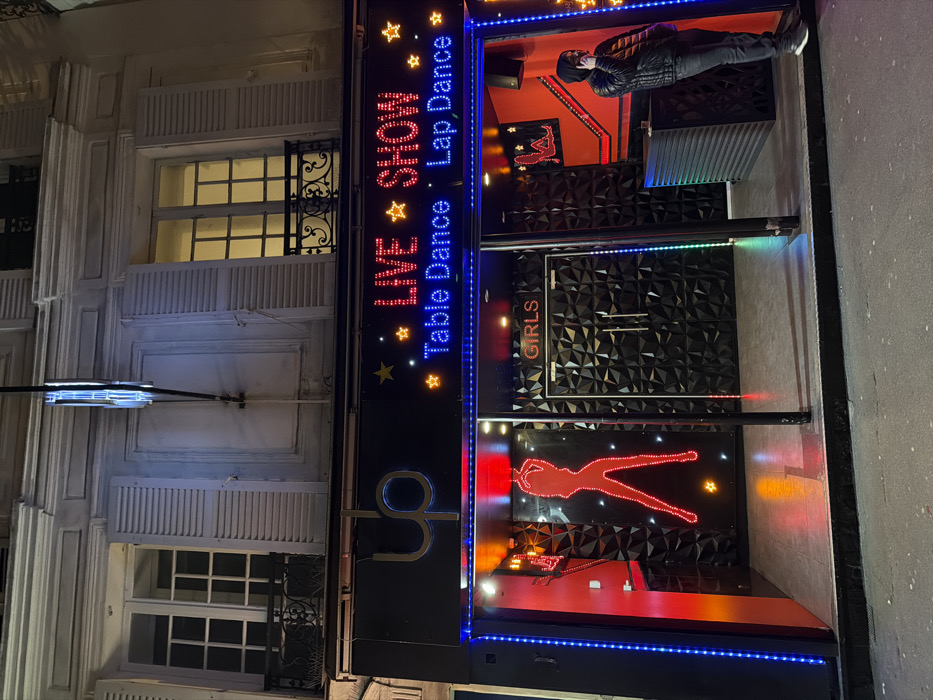 Paris nightlife district bustling with illuminated venues, entertainment establishments