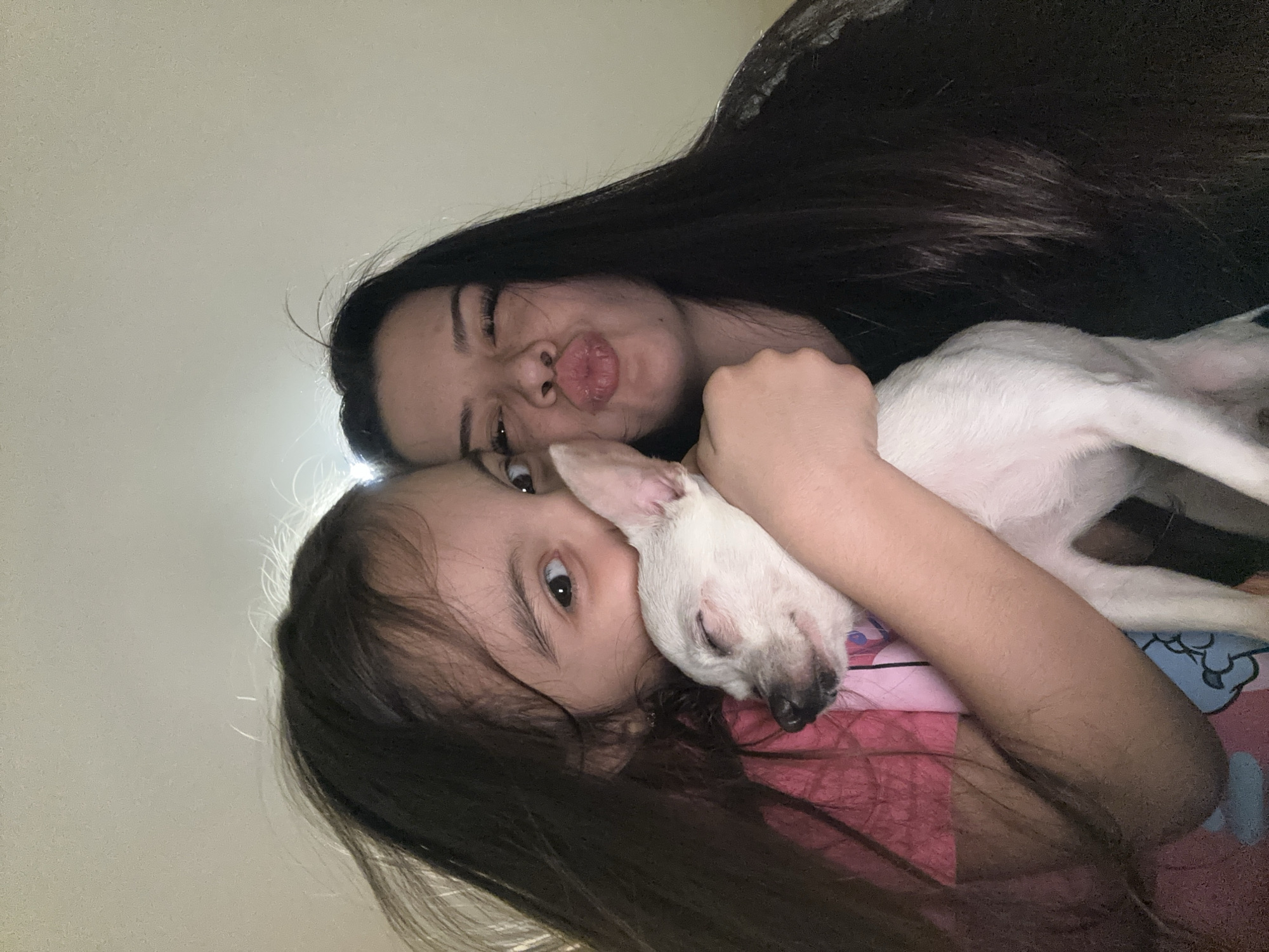 Woman and child pose with white dog in Bulgaria