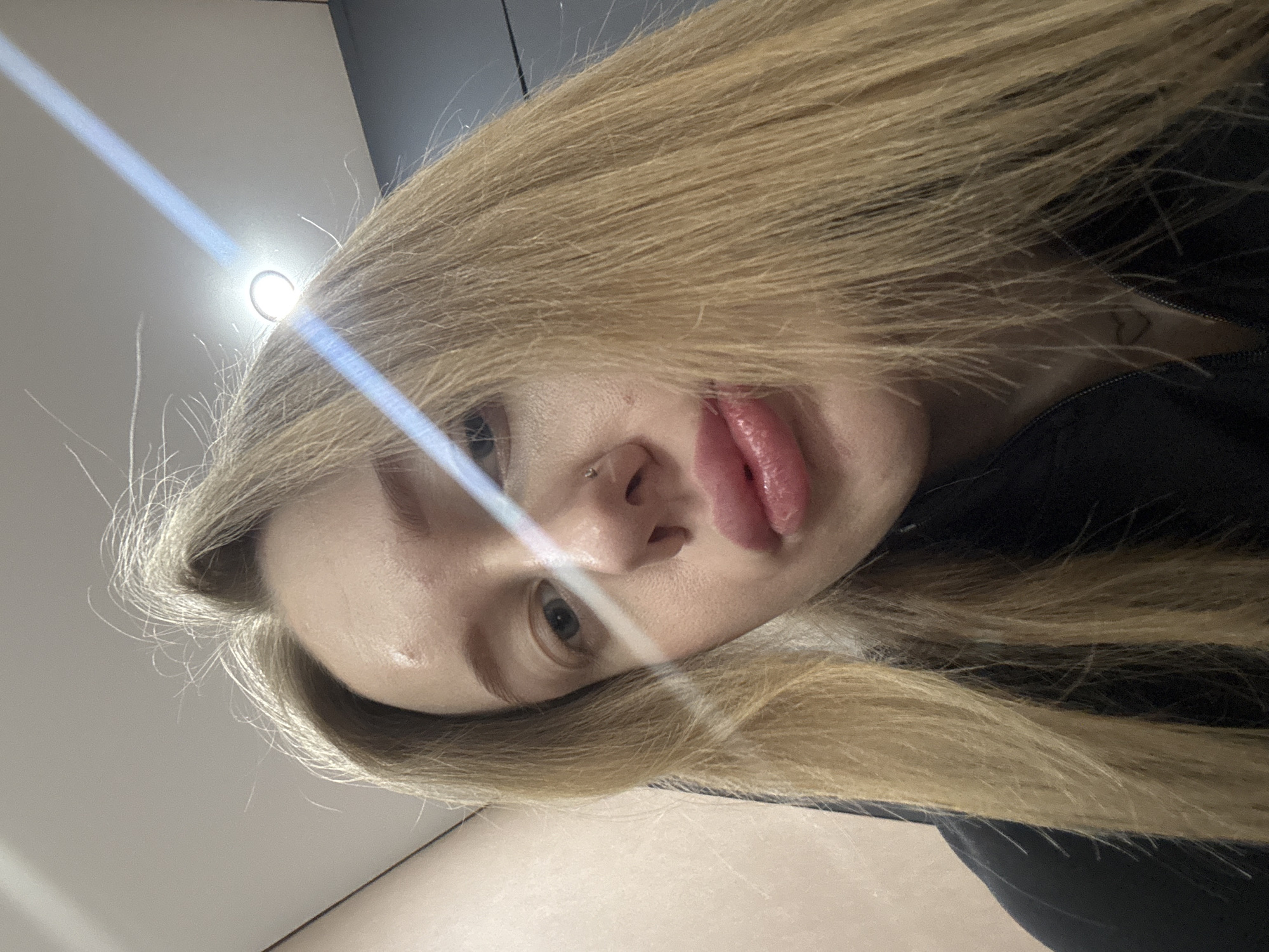 Woman takes multiple selfies indoors in Azov, Russia