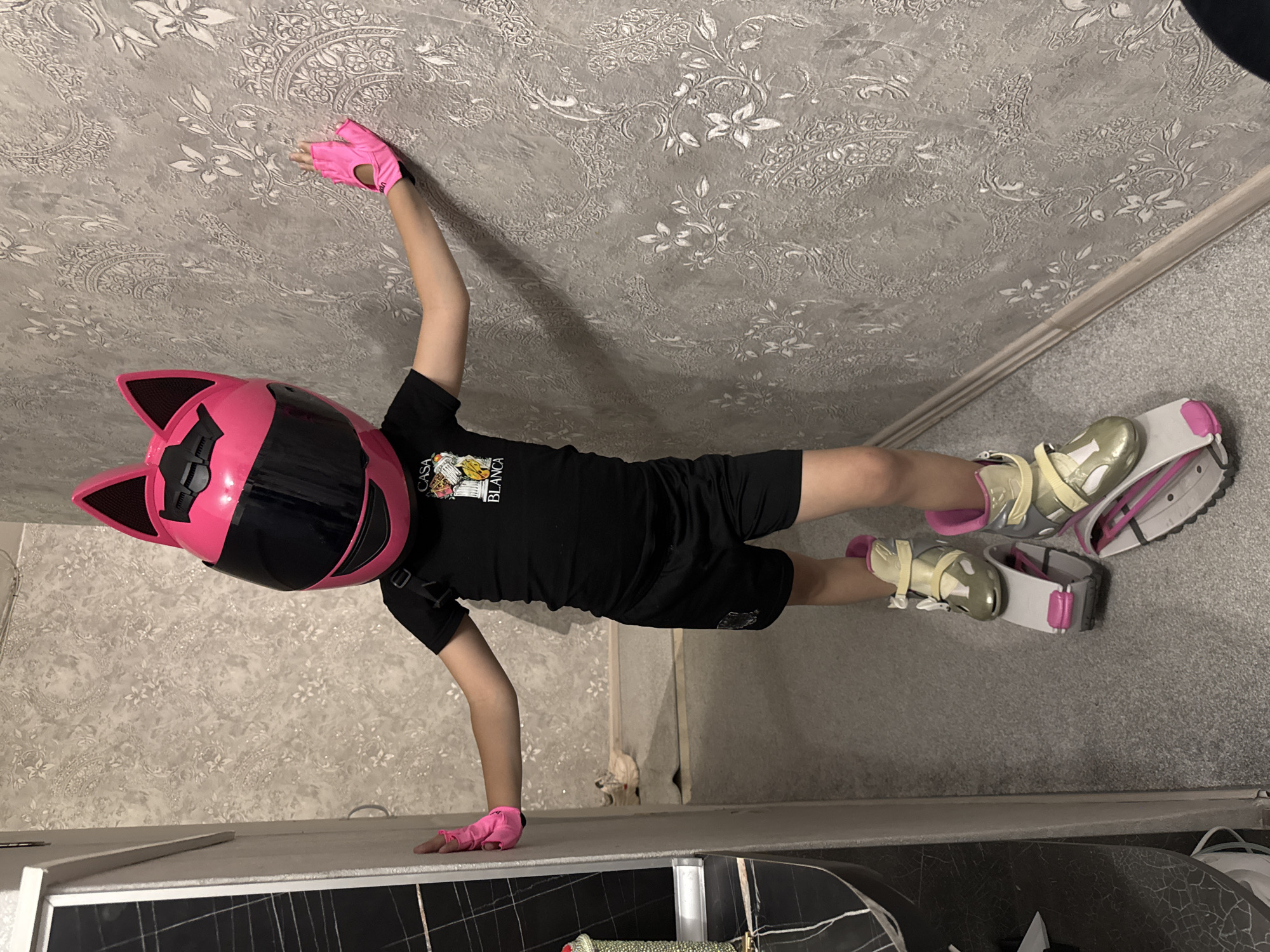 Child performs indoor gymnastics routine in Abakan home