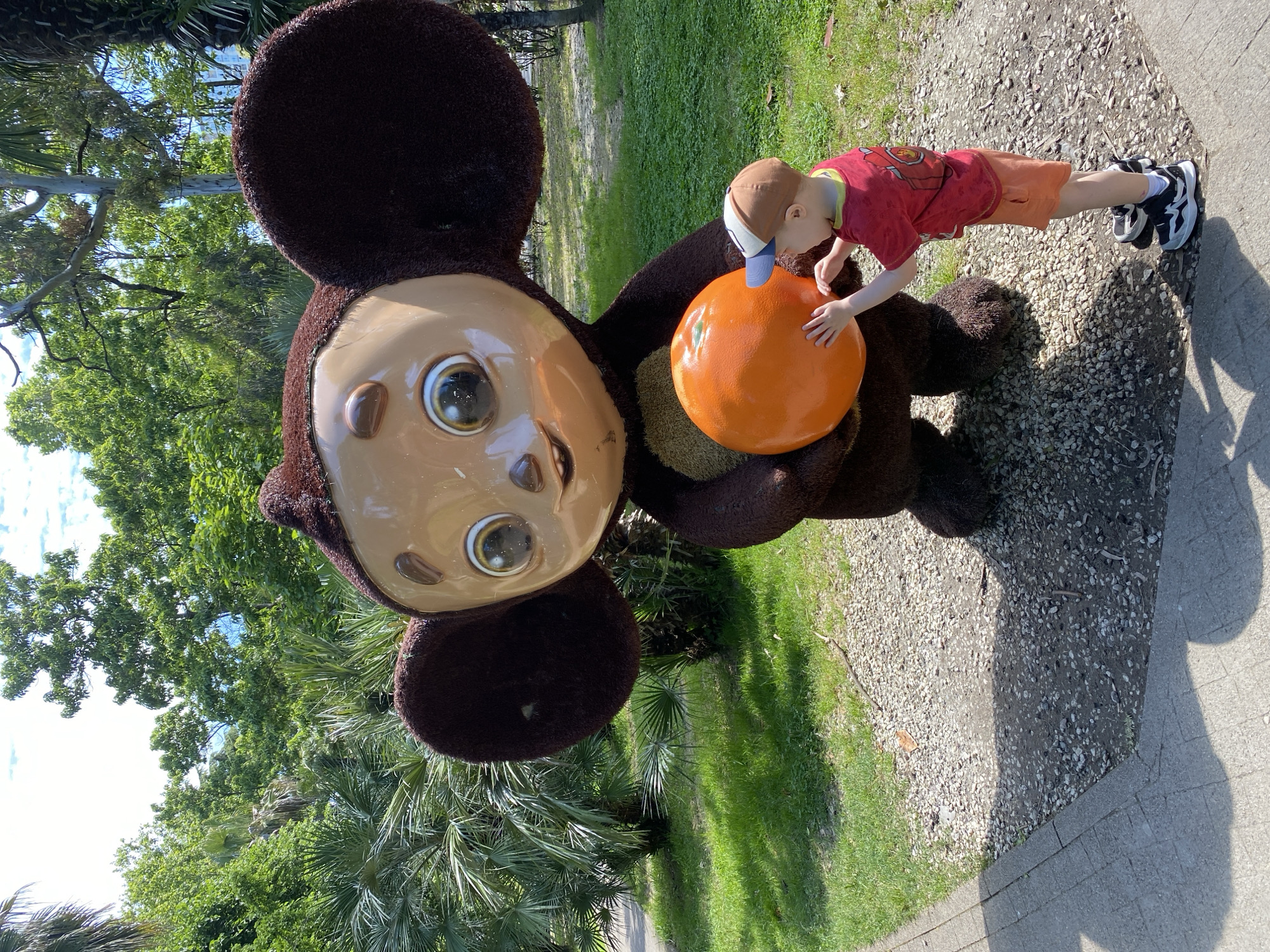 Child plays with Cheburashka statue in Sochi park
