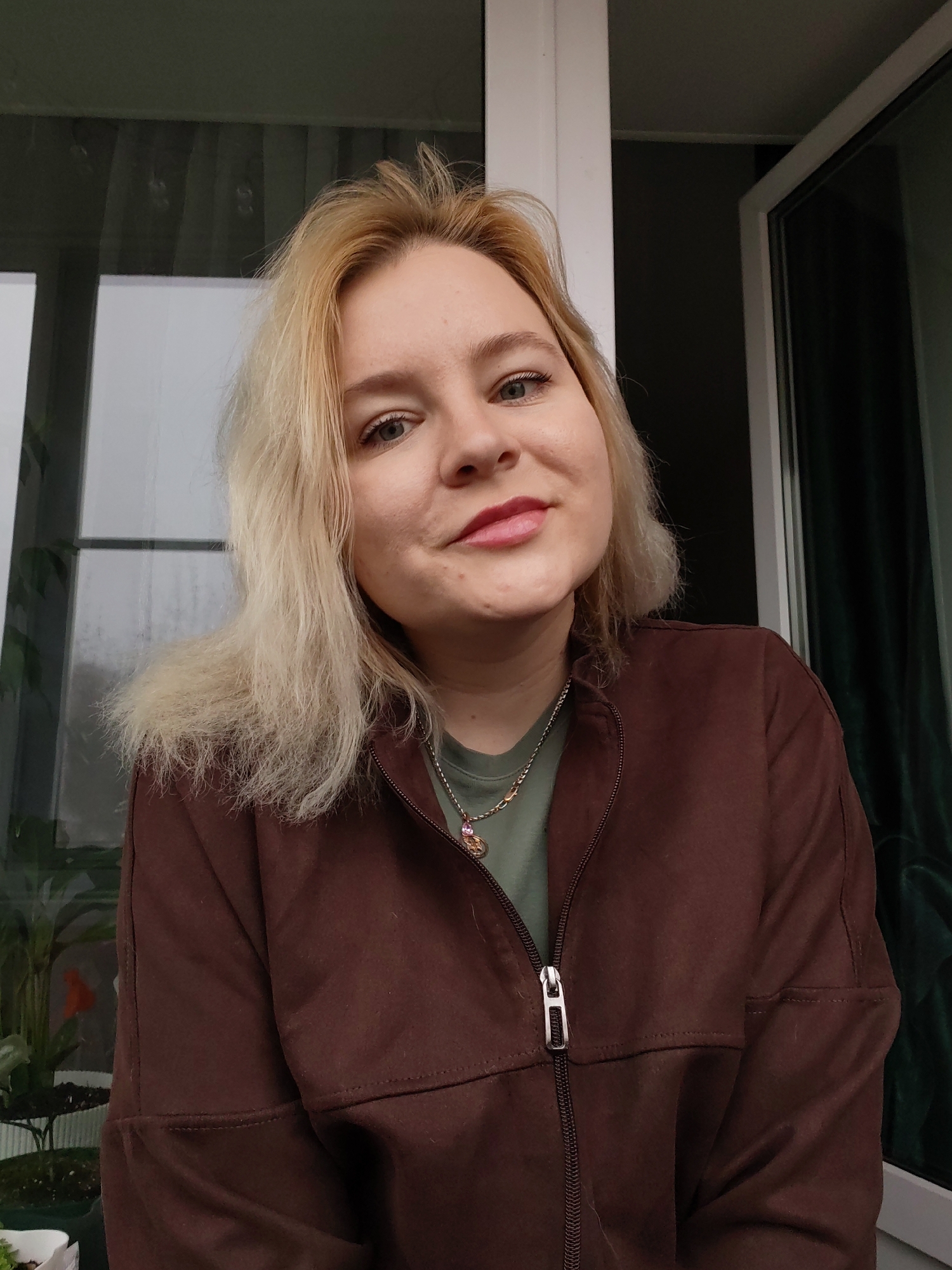 Woman observed indoors during rainy morning in Izhevsk