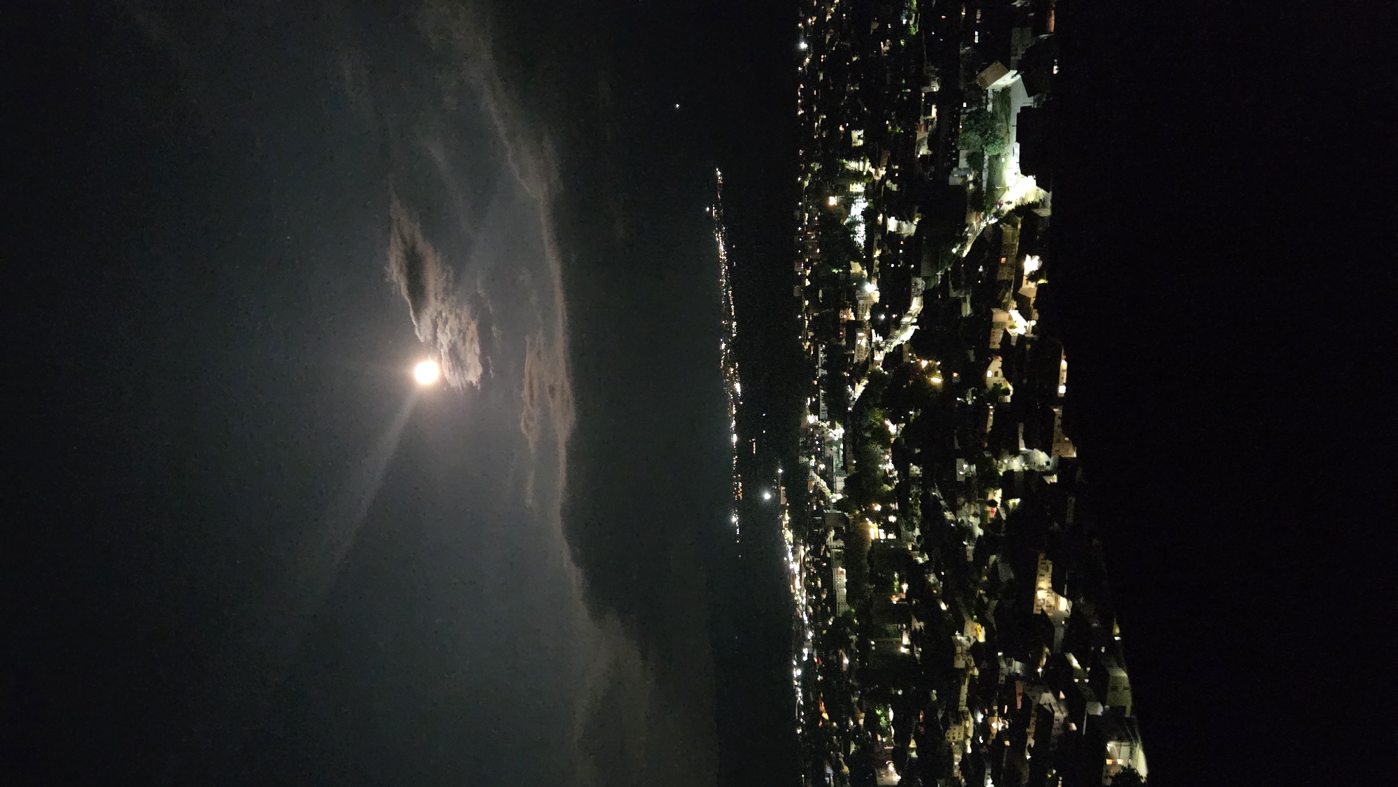Razlog at night, full moon over a lit city grid