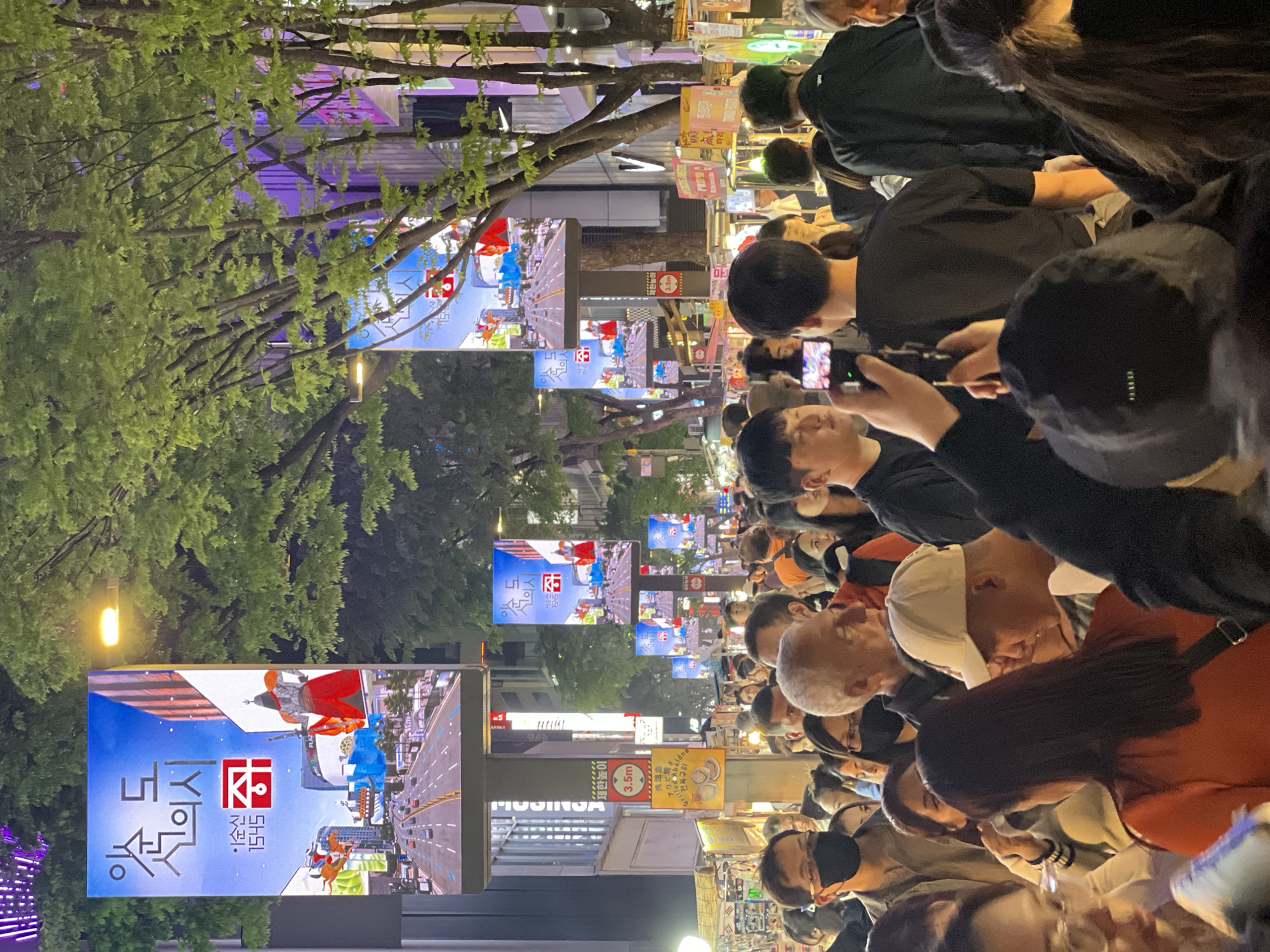 Dense crowds fill Seoul street during daytime hours