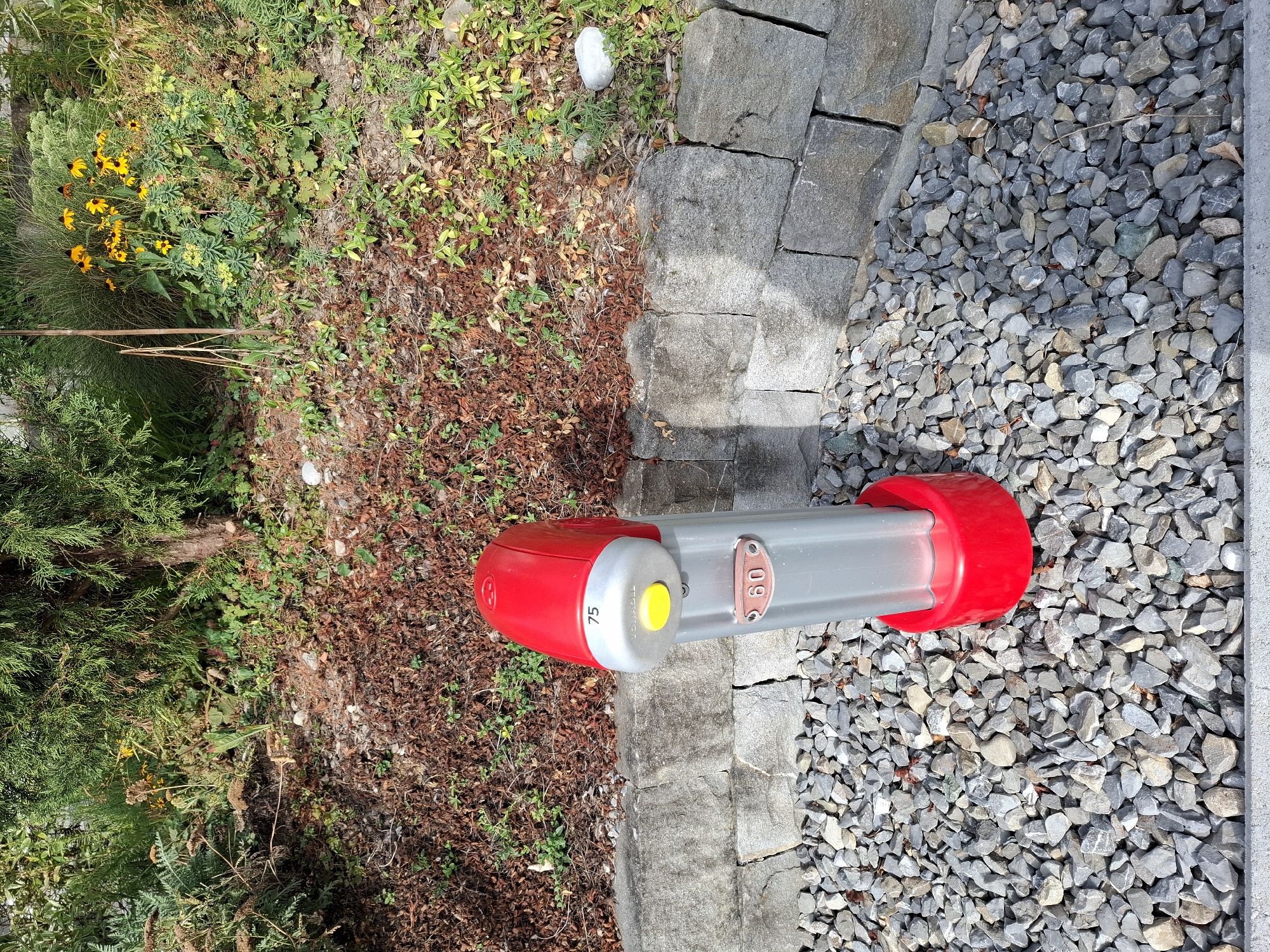 Bollard and blooms along a Swiss path in summer