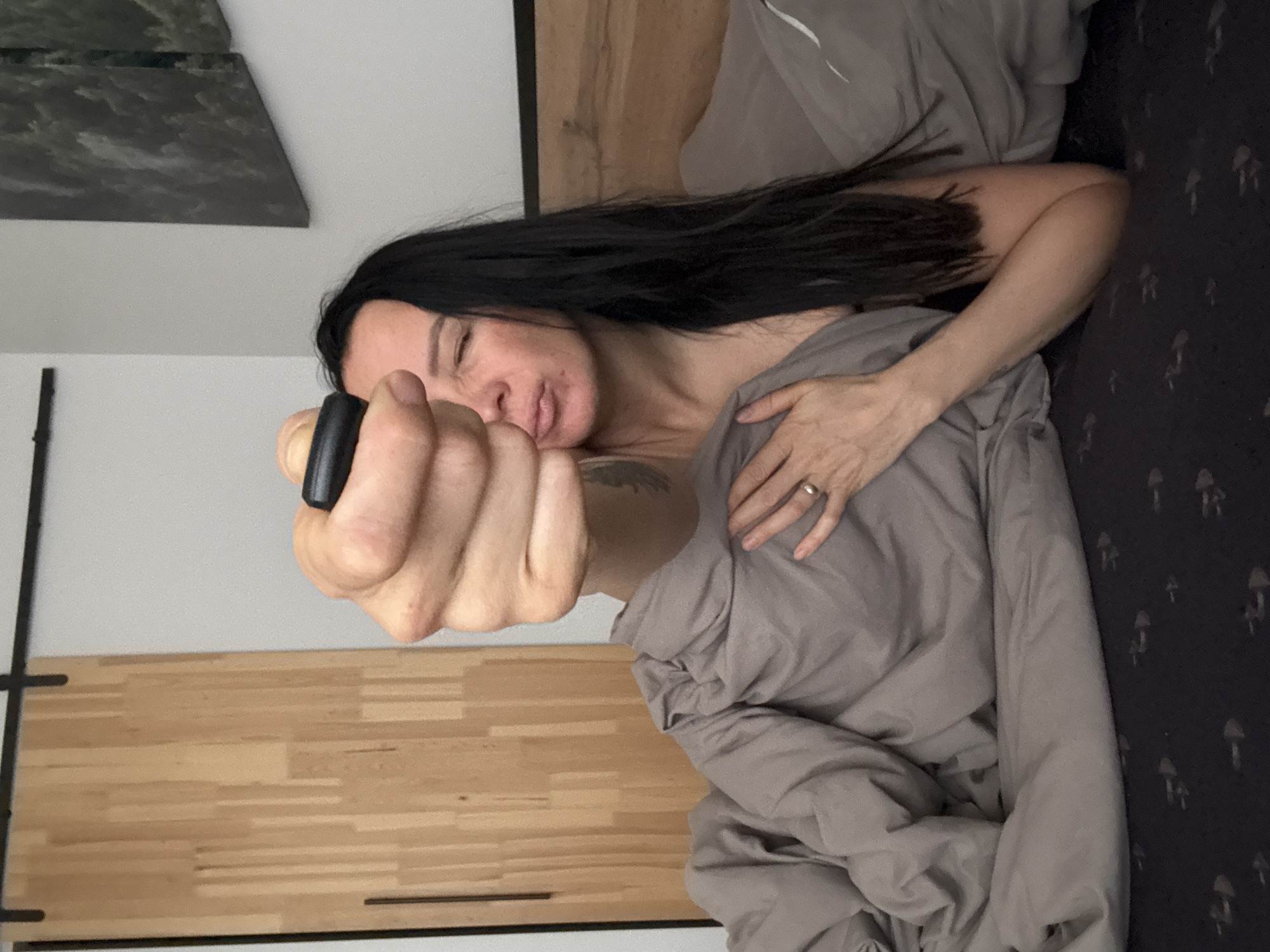 Woman photographed in bed during morning hours in Chaikovsky