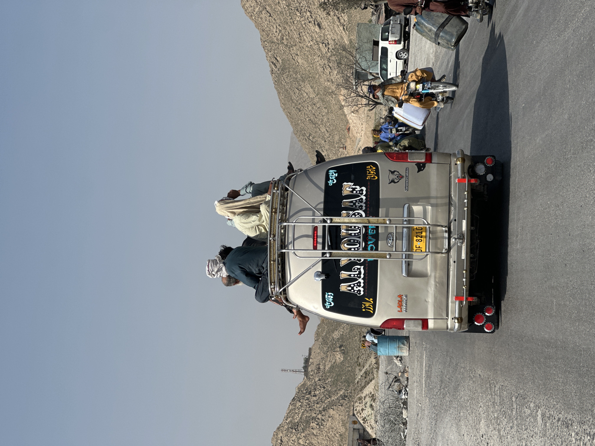 Overloaded van carries roof passengers in Quetta, Pakistan