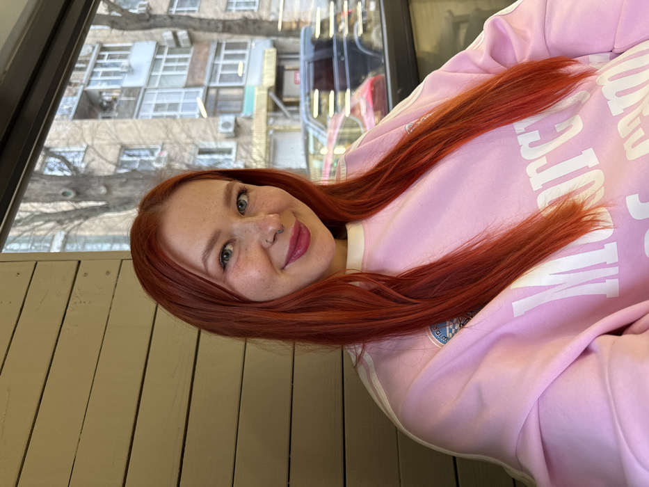 Red-haired woman documents afternoon cafe tour in Rostov-on-Don
