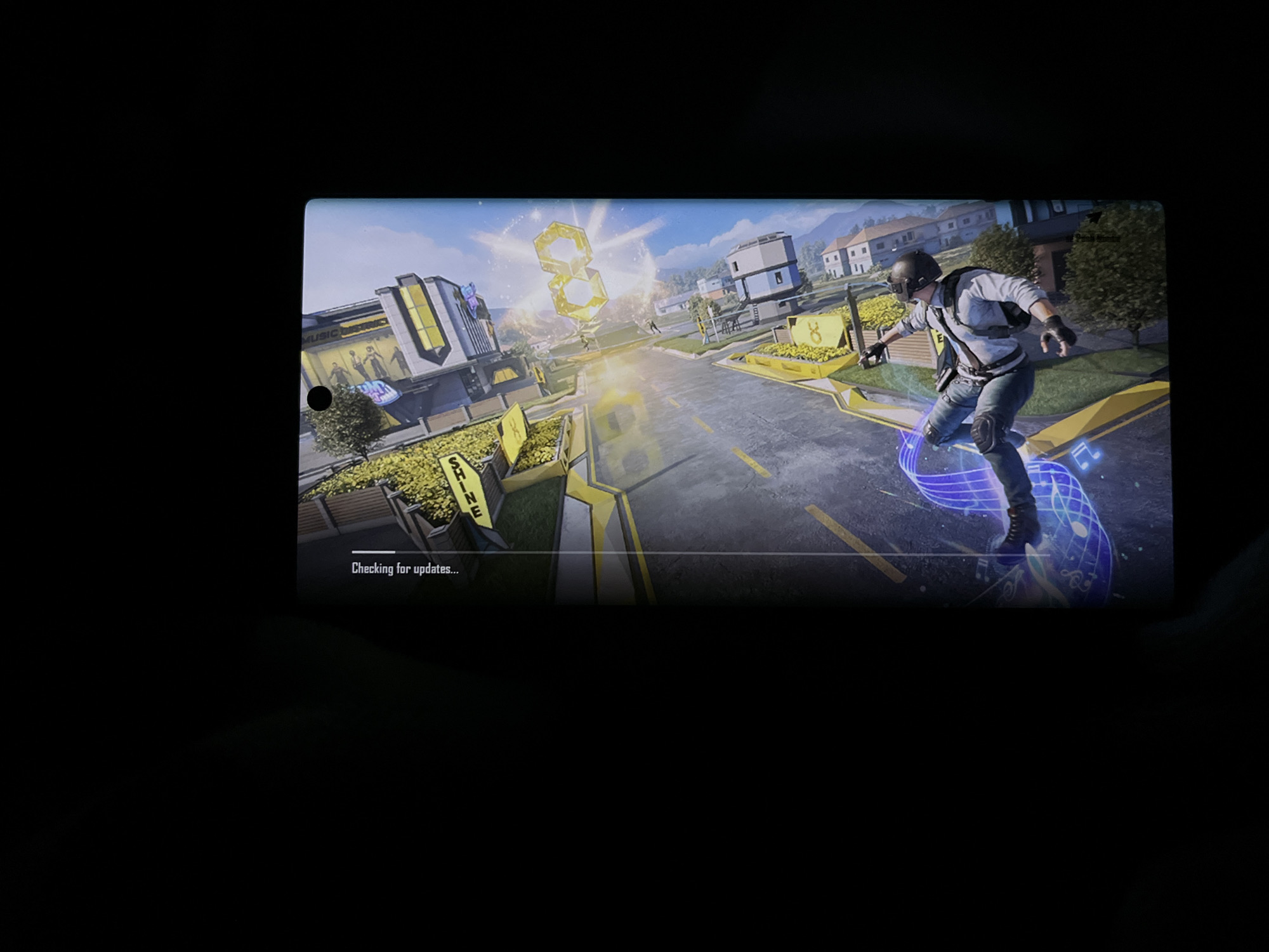 Mobile gaming session captured in darkened Uitenhage environment