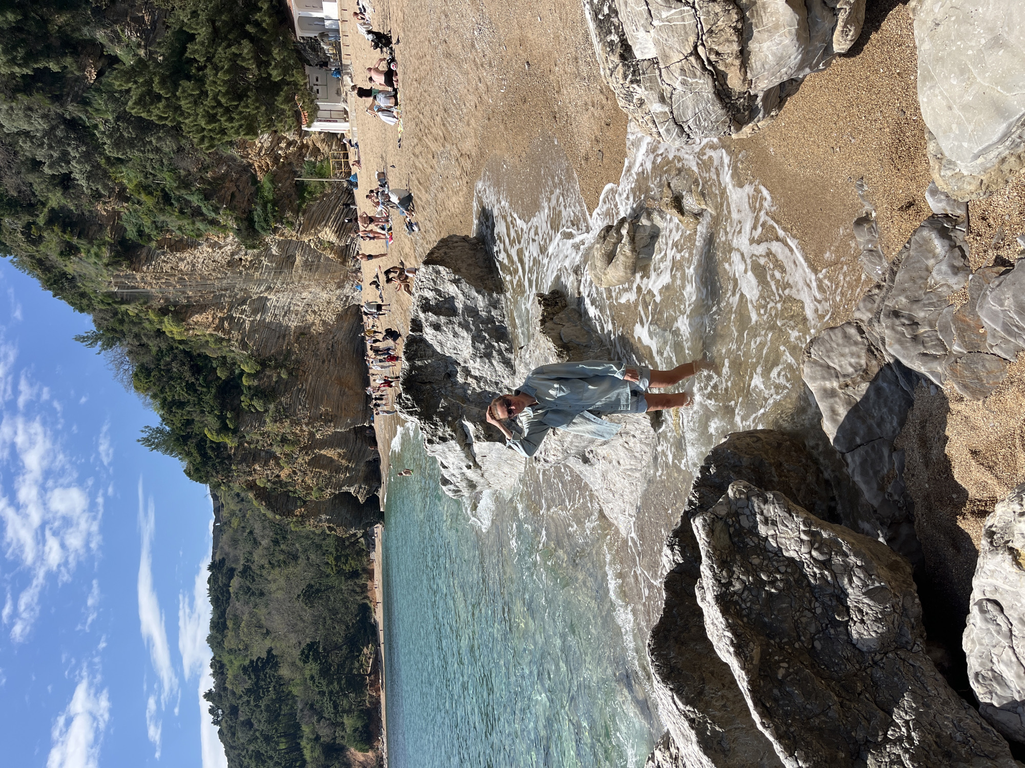 Woman relaxes in water at Pržno beach, Montenegro