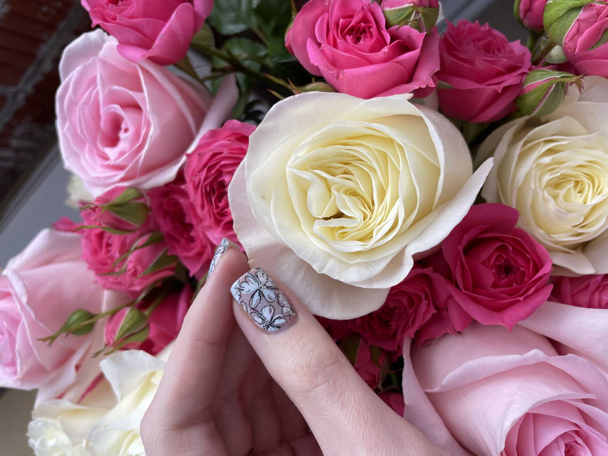 Person rests peacefully with rose bouquet in Izhevsk