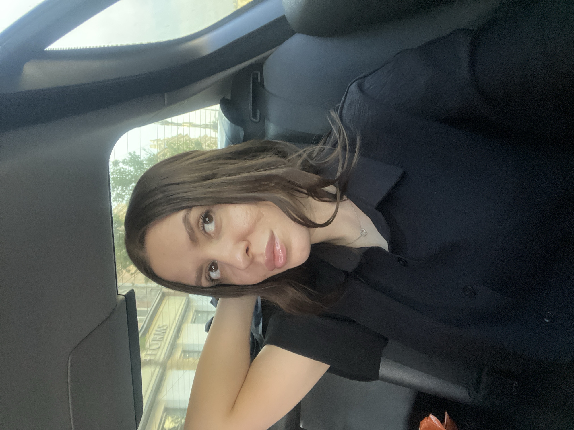 Woman in black shirt observed in car backseat, Moscow