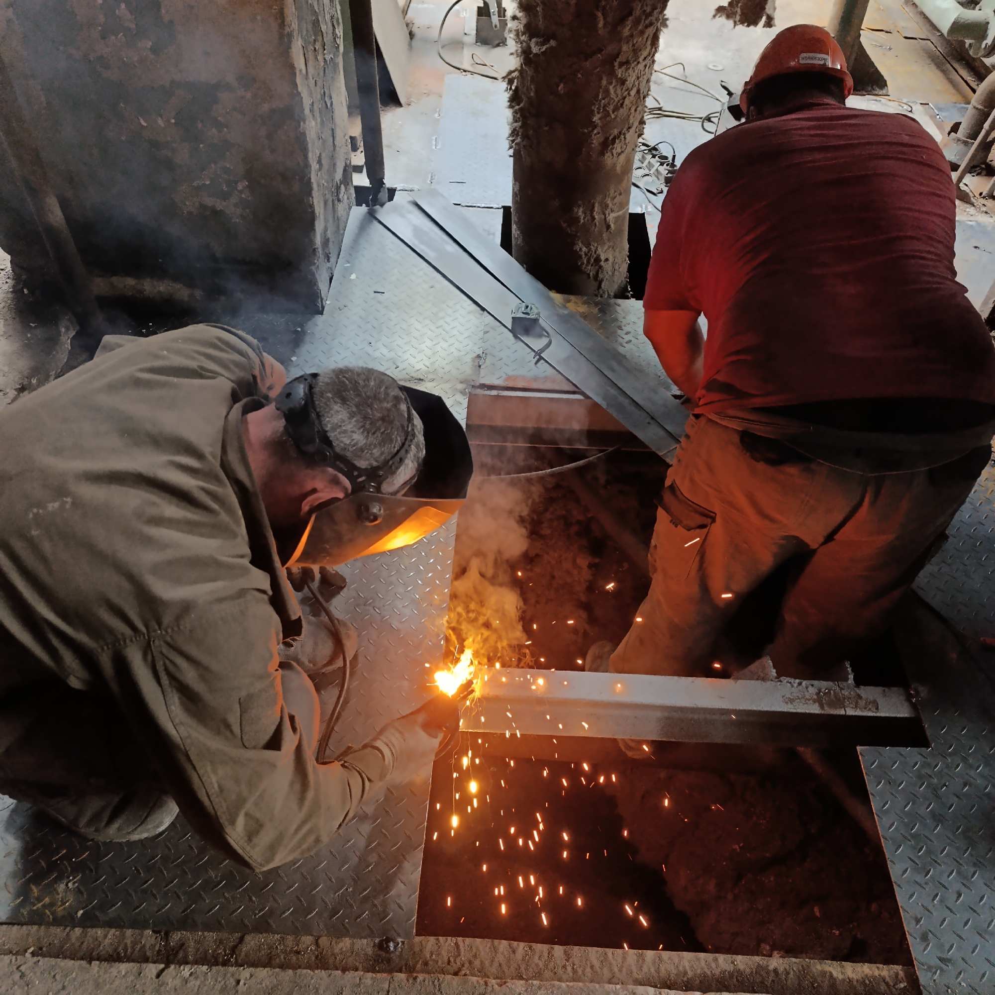 Welders at work on metal in a Ladyzhyn industrial site