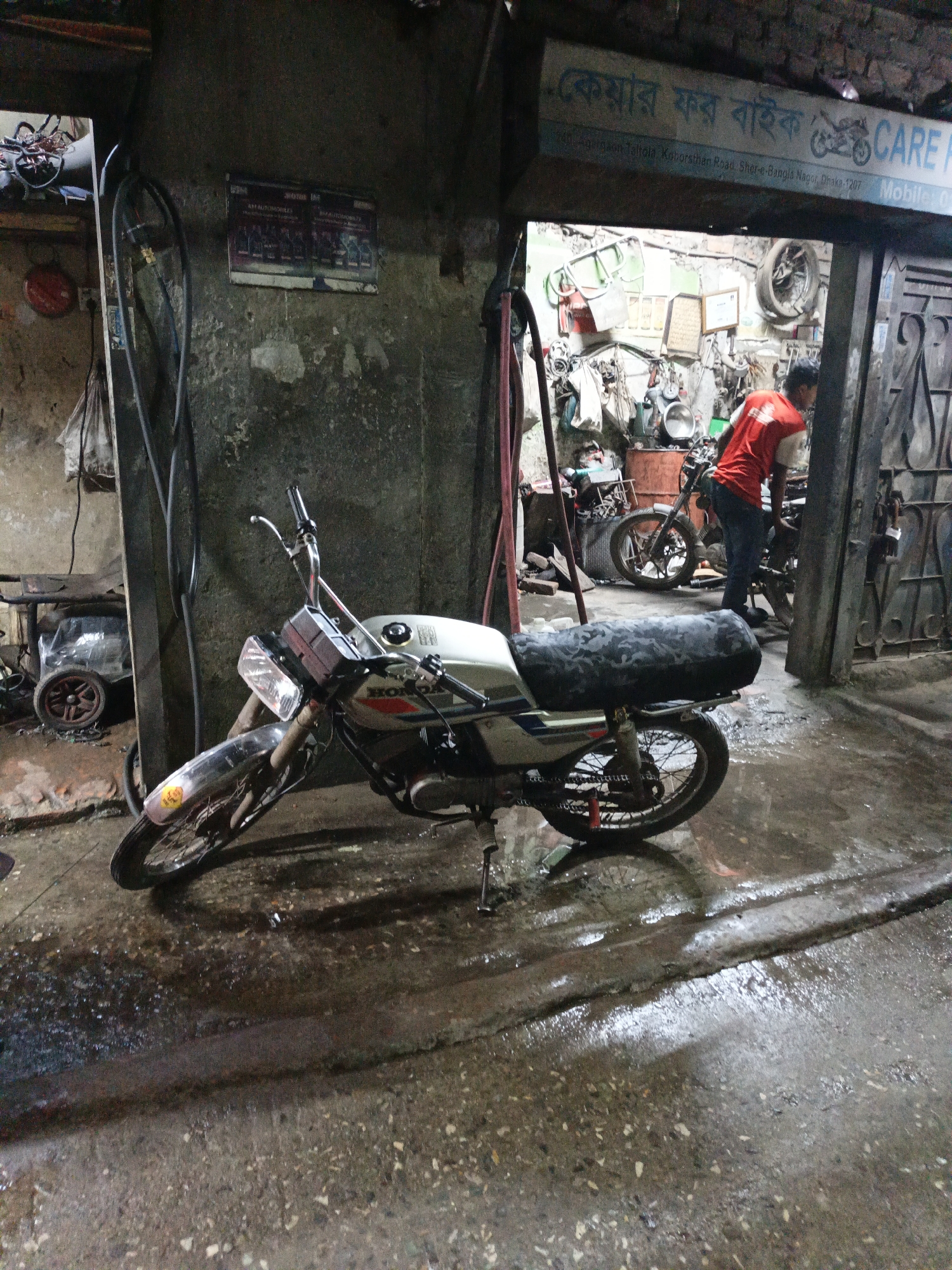 Motorcycle mechanics at work in Dhaka repair shop