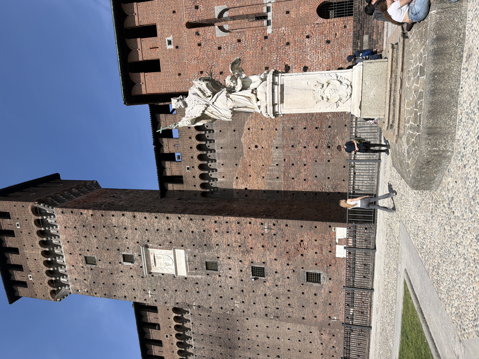 Tourist captures statuary at Milan's Sforza Castle