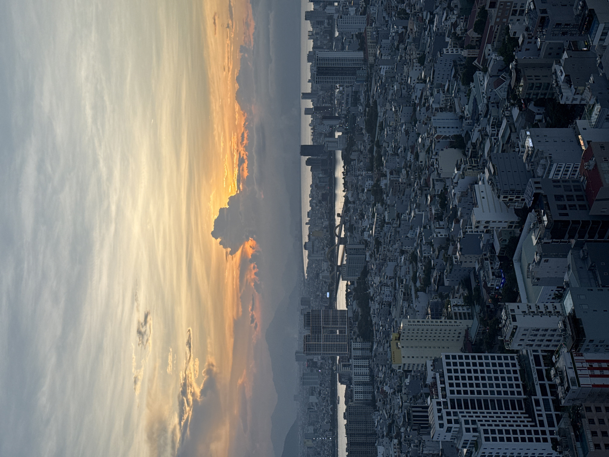 Da Nang at sunset: crowded beaches and city skyline from above