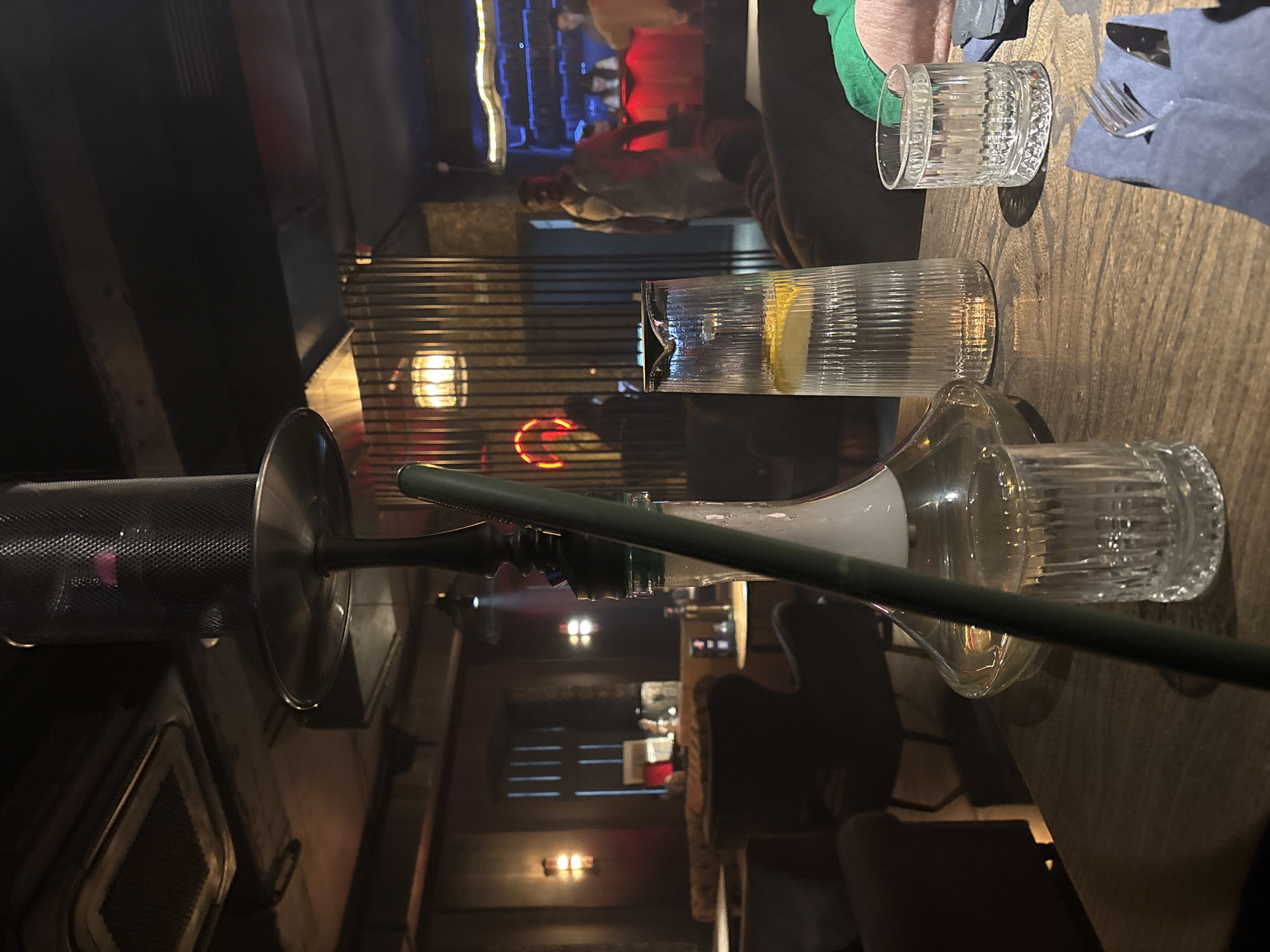 Hookah lounge interior in Kazan with books, busts, and food