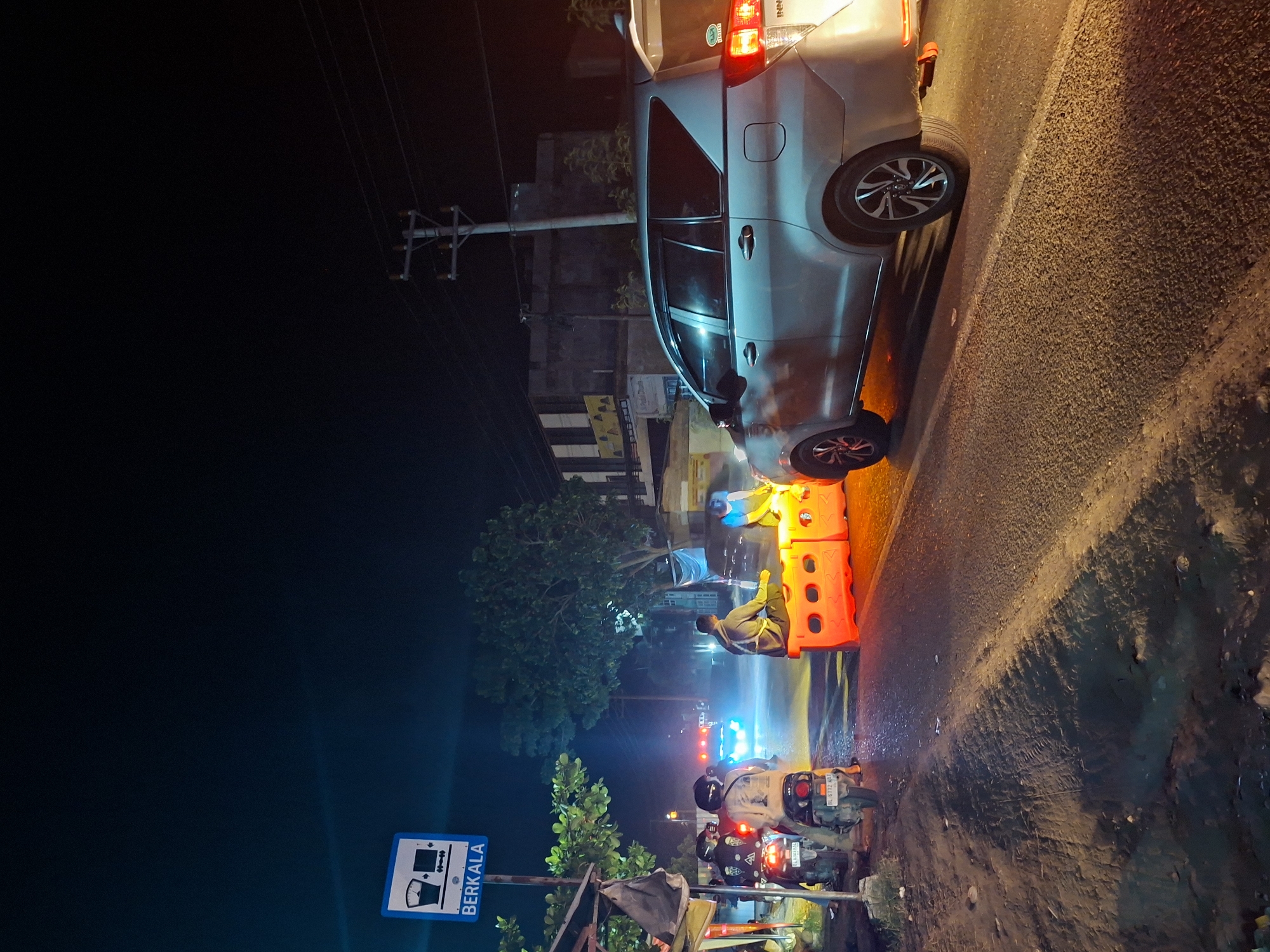 Vehicle parked on wet road in Lhokseumawe, Indonesia